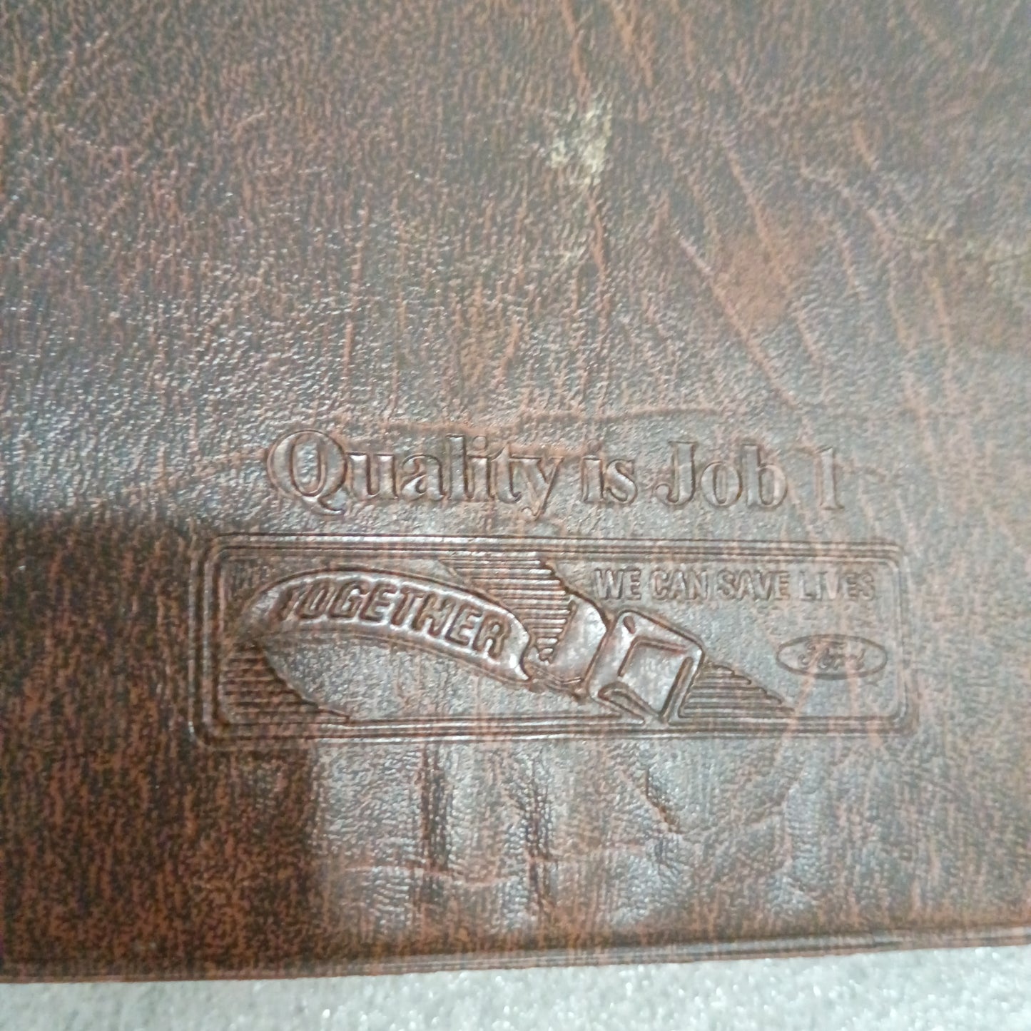 Brown embossed Ford manual cover with "Quality is Job 1" text, showing moderate wear. Suitable for 1996 F-Series trucks.