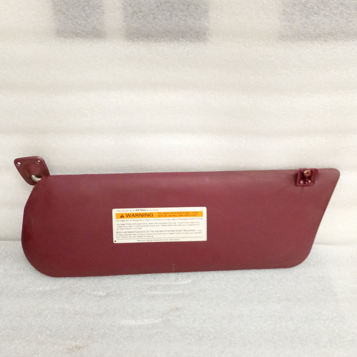 Dark red vinyl sun visor with hinges and warning label, compatible with 1992-1997 Ford Bronco, F-150, F-250, F-350. OEM Ford part.