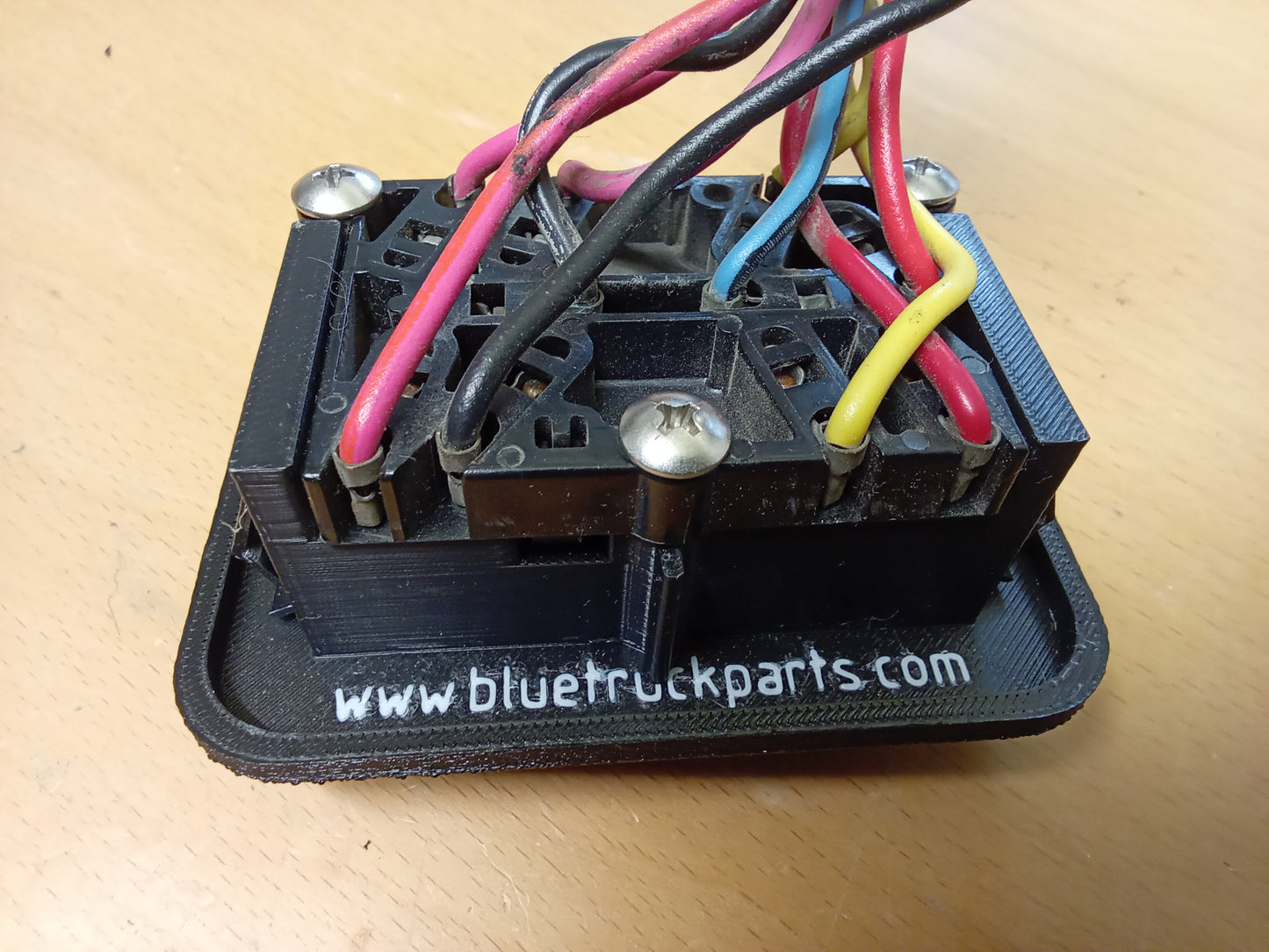 Power window and lock bezel for 1987-1991 Ford F-150/F-250/F-350/Bronco, showing wiring and mounting screws.