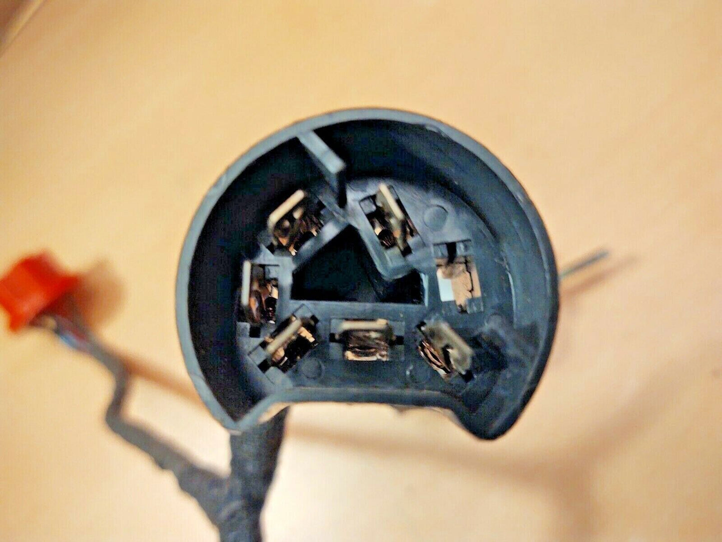 Close-up of the black plastic multi-pin electrical connector plug with metal terminals, part of an OEM Ford intermittent delay wiper switch module.