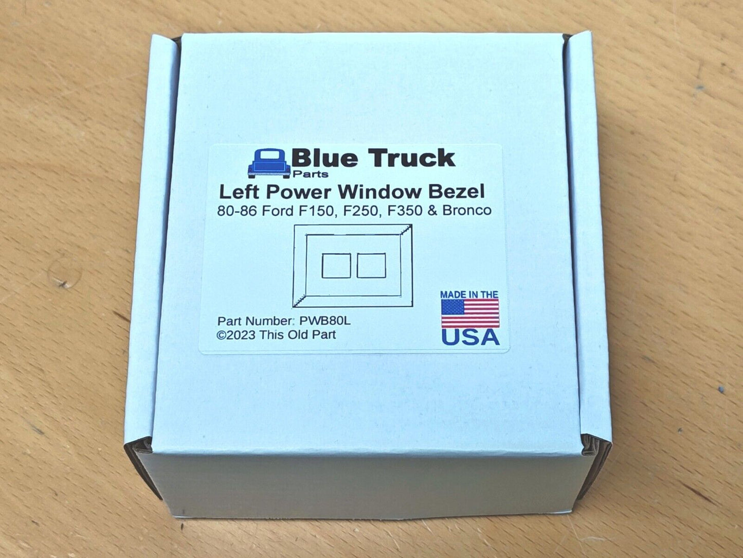 Packaging box for Blue Truck Parts Left Power Window Bezel, part number PWB80L, compatible with 1980-1986 Ford F150, F250, F350, and Bronco. The label includes a schematic drawing and a Made in the USA logo.