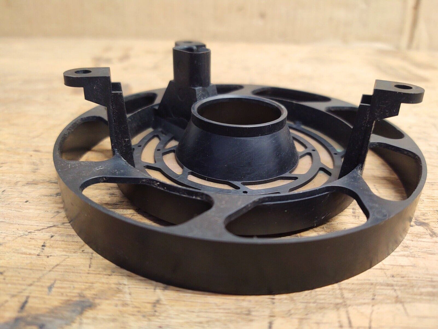 OEM Ford black plastic steering wheel clock spring and cancel cam with three upright mounting tabs, compatible with 1992 to 1996 Ford F-150, F-250, F-350, and Bronco models.