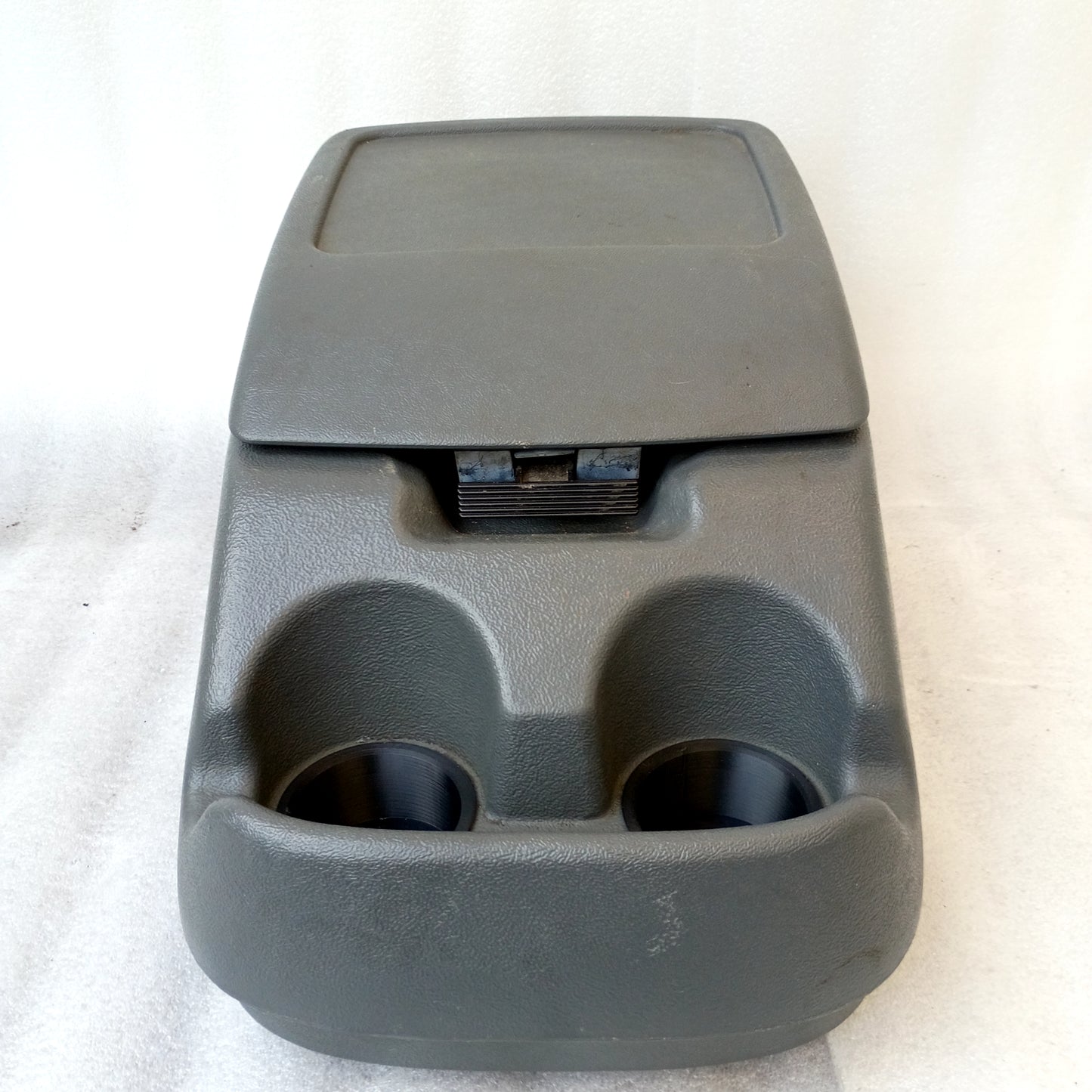Dark granite gray center console for 1992-1997 Ford trucks, featuring cup holders and latch, in very good condition.