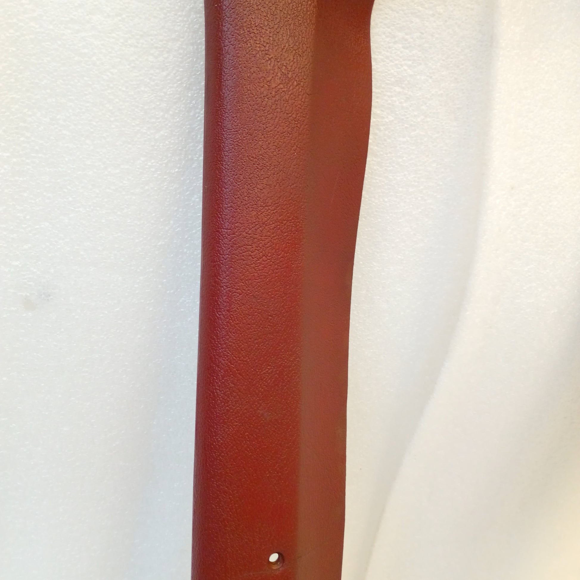 Red A pillar trim piece for 1980-1986 Ford F150, F250, F350, Bronco; original condition with minor blemishes.