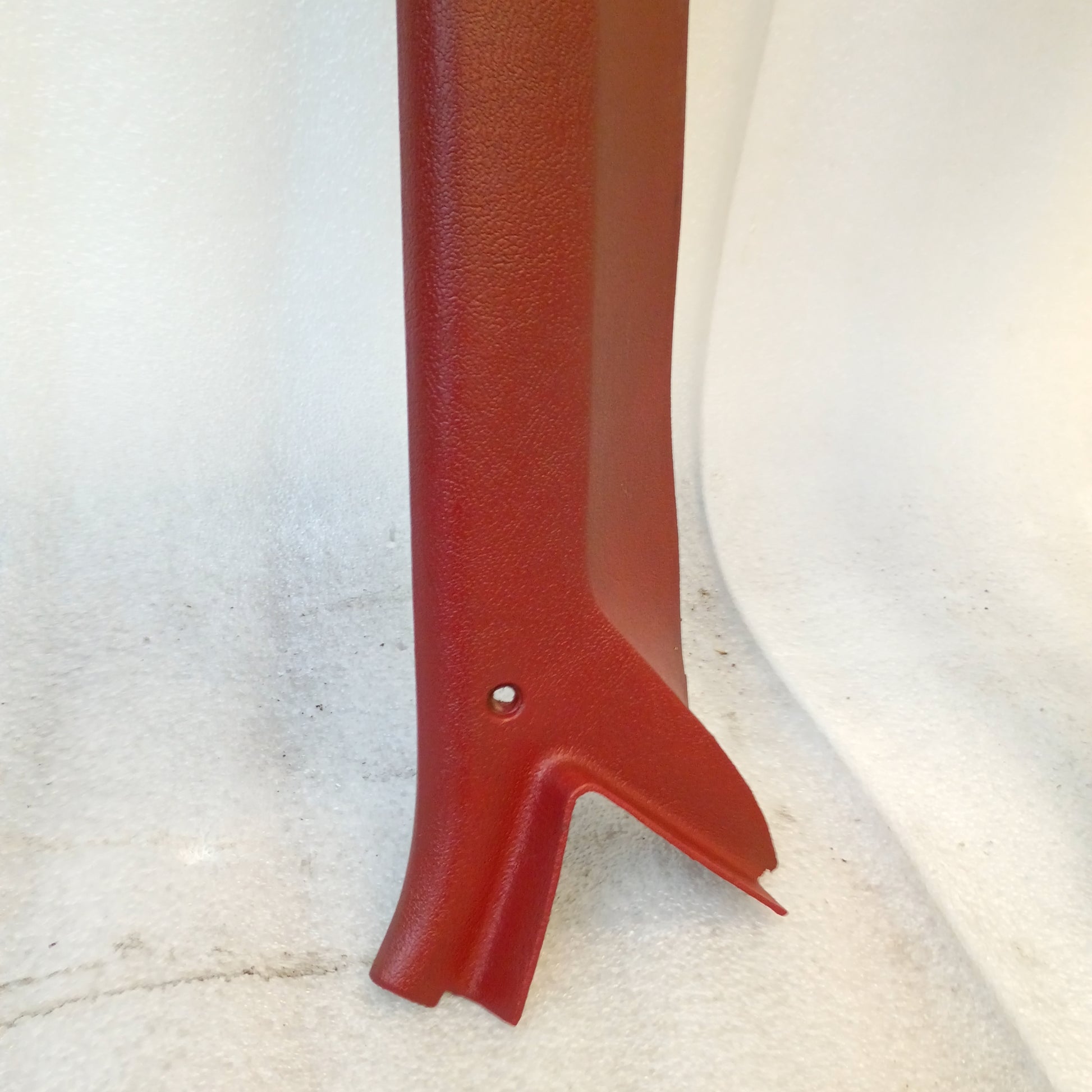 Red A Pillar Trim piece for 1980-1986 Ford F150, F250, F350, Bronco, showing textured surface and mounting hole.