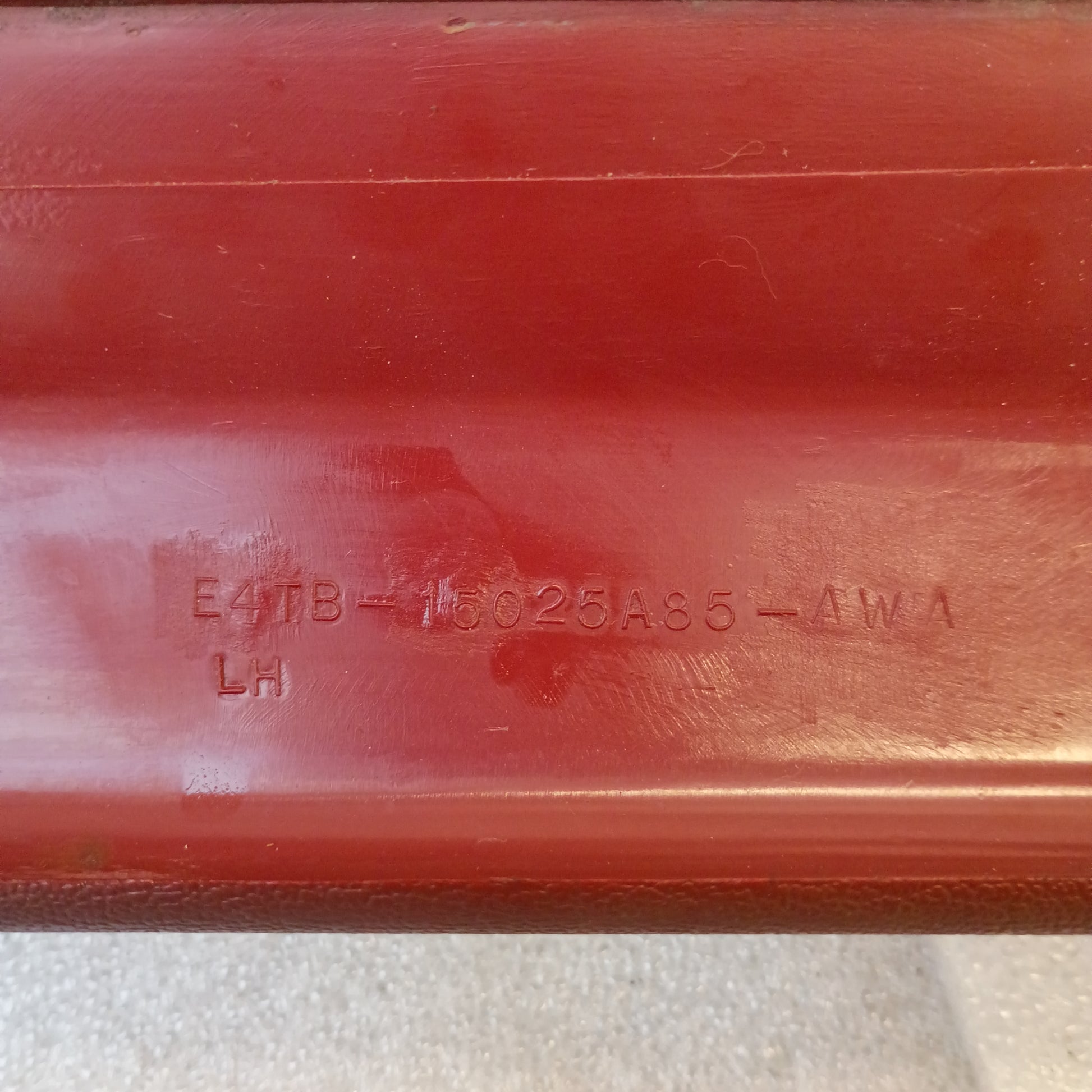 Red Ford A-pillar trim with part number E4TB-15025A85-AWA, compatible with 1980-1986 F-Series and Bronco, showing minor blemishes.
