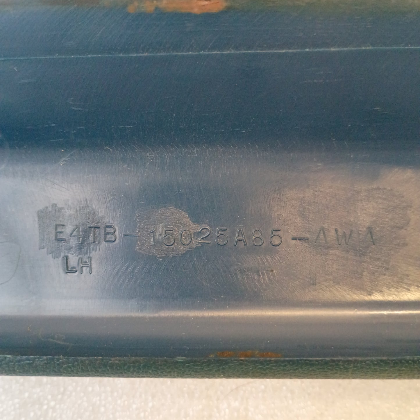 Close-up of Ford A-pillar trim in Harbor Blue with part number E4TB-15025A85-AWA, showing slight blemishes.
