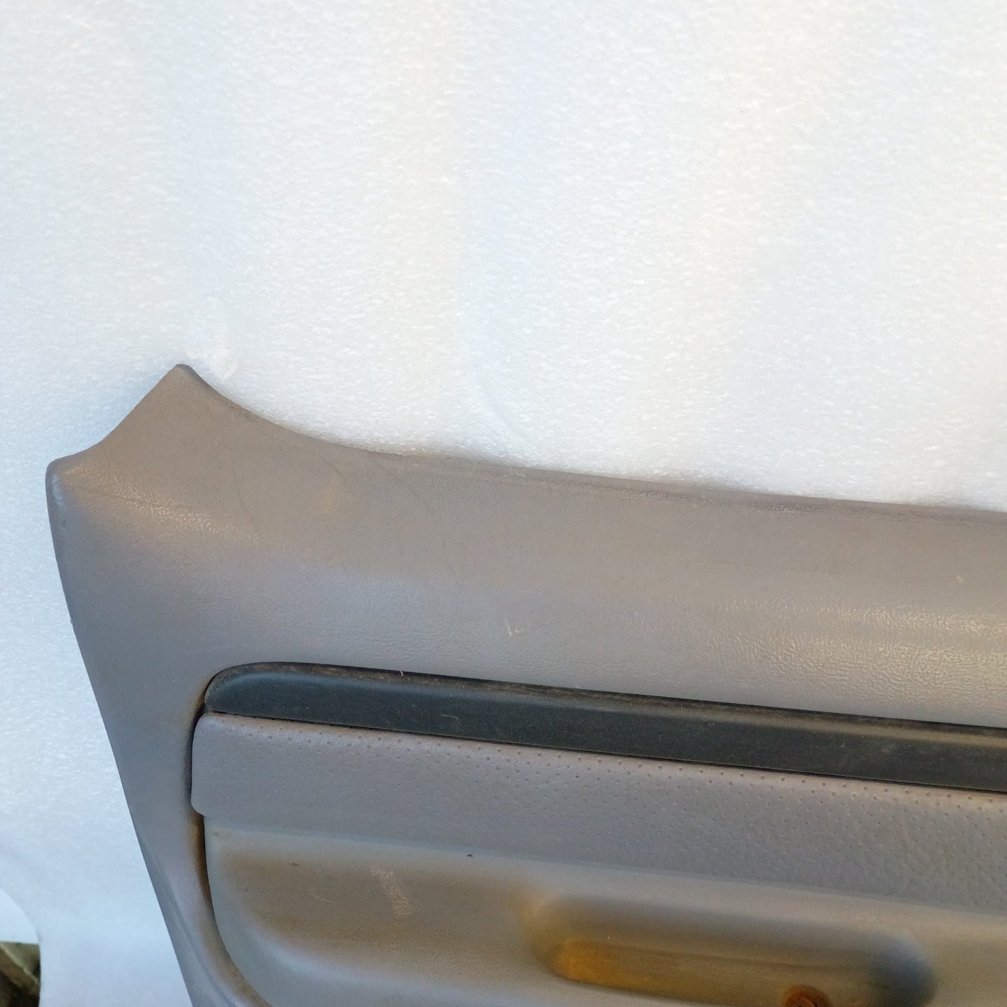 Gray rear crew cab door panel for Ford F250/F350, 1992-1997. Features vinyl armrest and good condition plastic.