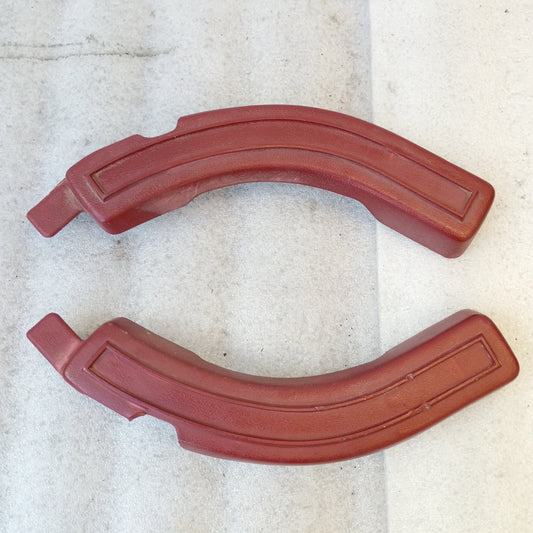 Red bench seat hinge covers for Ford 1980-1986 Bronco, F-150, F-250, F-350; iridescent finish, metal clip attachment.
