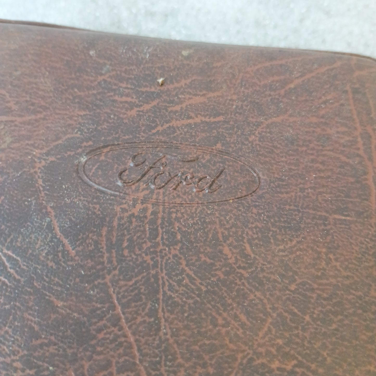 Brown vinyl padded cover with embossed Ford logo, part of the 1990 Diesel F-Series Owner Guide and Maintenance Schedule set.