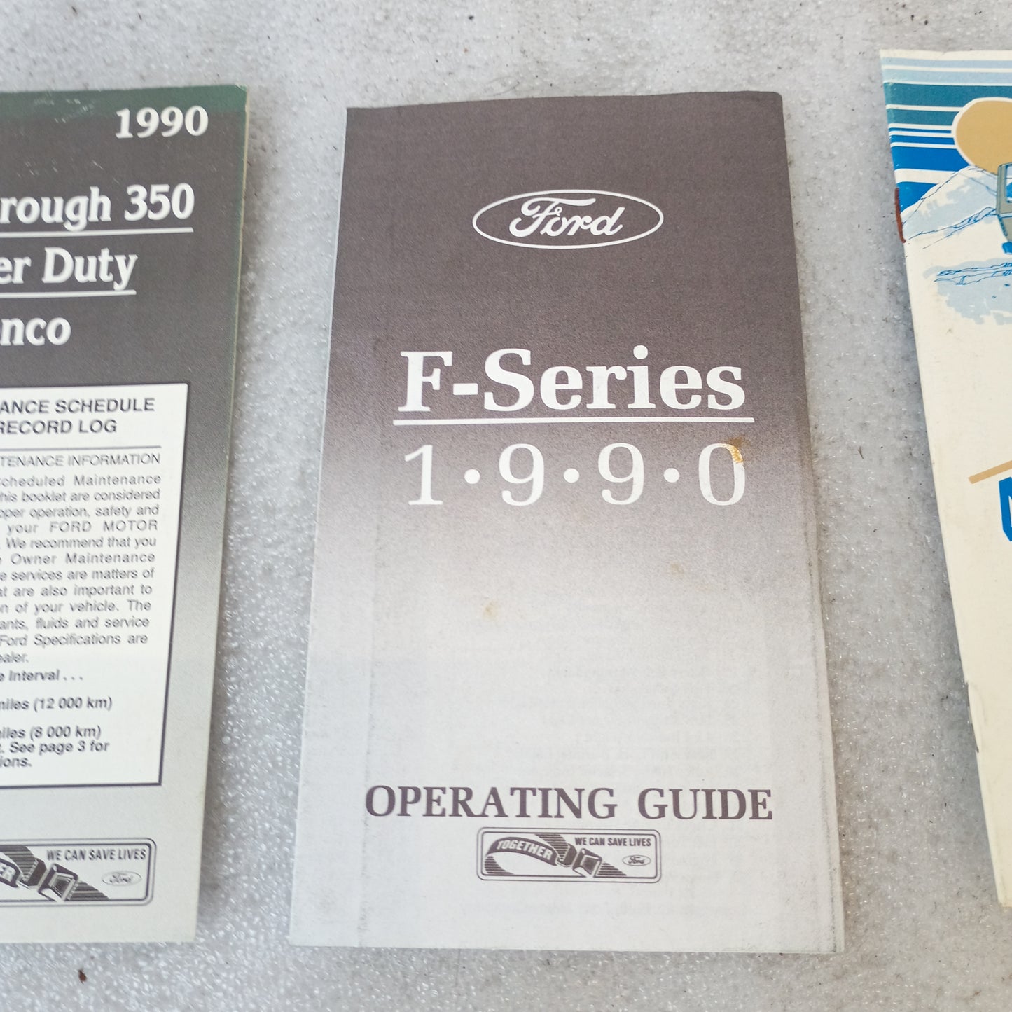 1990 Ford F-Series Operating Guide and Maintenance Booklets for F150, F250, F350, and Bronco displayed on a surface.