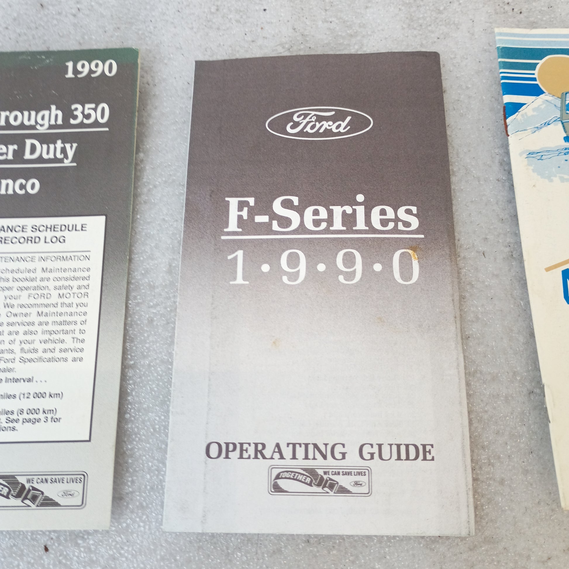 1990 Ford F-Series Operating Guide and Maintenance Booklets for F150, F250, F350, and Bronco displayed on a surface.