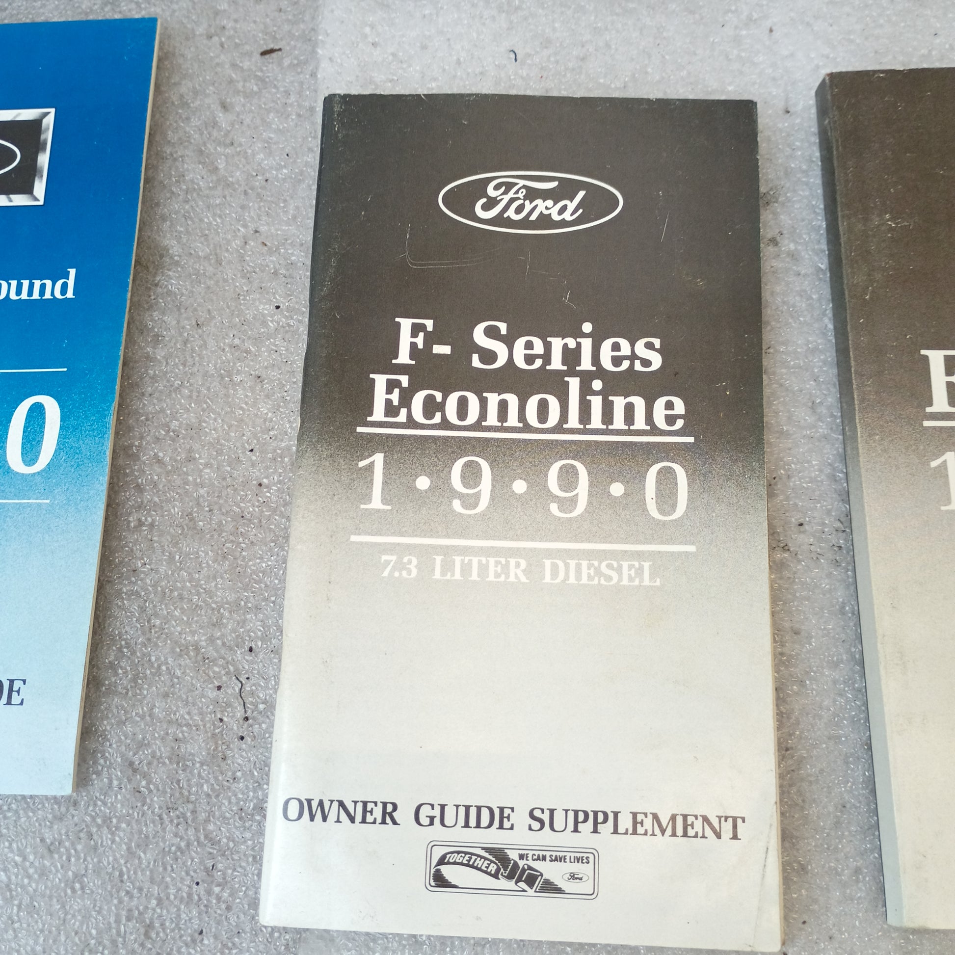 1990 Ford F-Series Econoline 7.3 Liter Diesel Owner Guide Supplement, gray cover, on display.