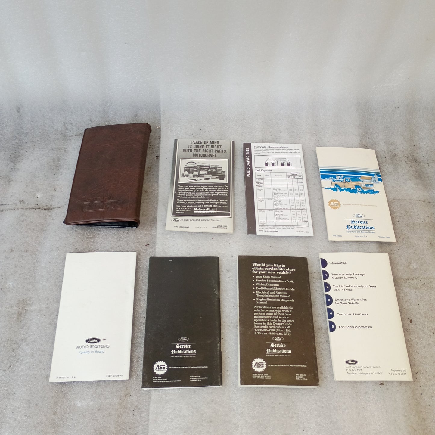 1990 Ford F-Series manuals and guides, including owner's guide, maintenance schedule, and vinyl case for F150, F250, F350, and Bronco.