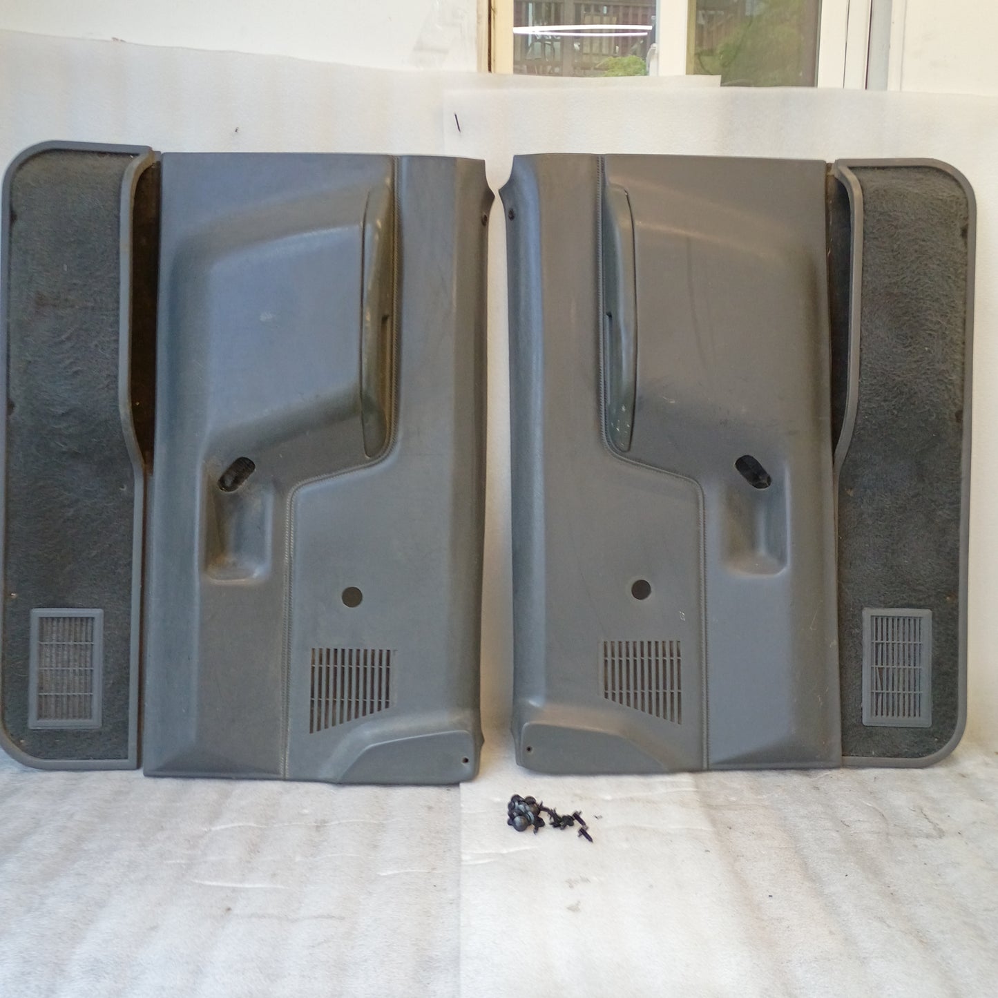 Dark gray door panels set for manual windows on Ford trucks and Bronco, 1987-1991. Left and right sides shown.