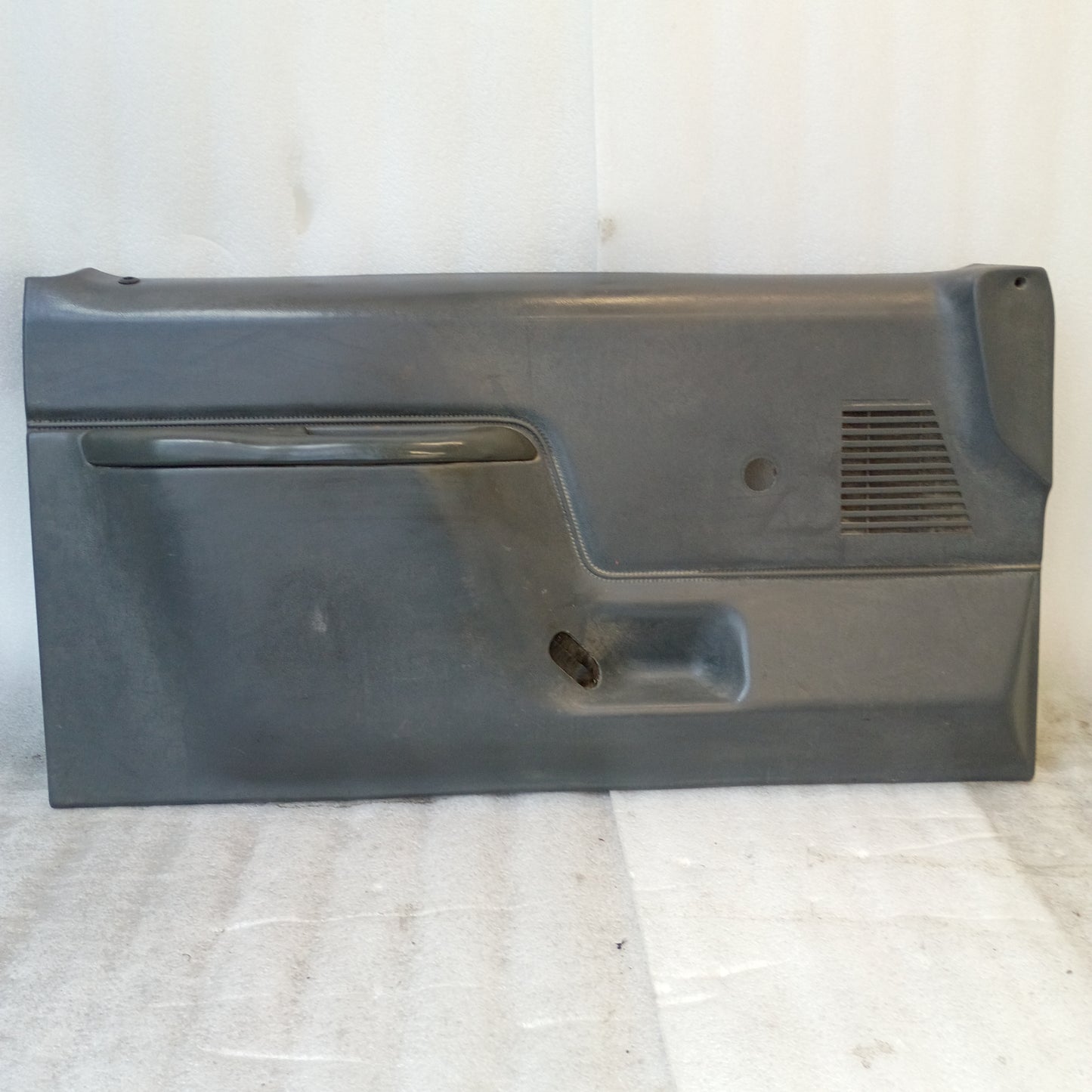 Dark gray door panel with manual window crank hole and speaker grill, compatible with 1987-1991 Ford F150, F250, F350, Bronco.