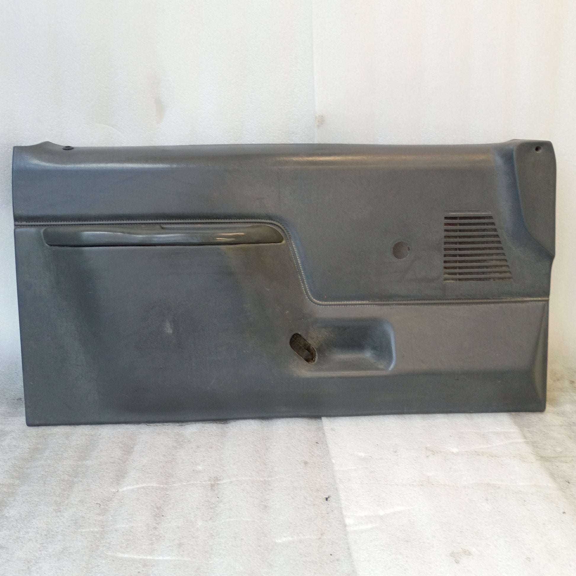 Dark gray door panel with manual window crank hole and speaker grill, compatible with 1987-1991 Ford F150, F250, F350, Bronco.