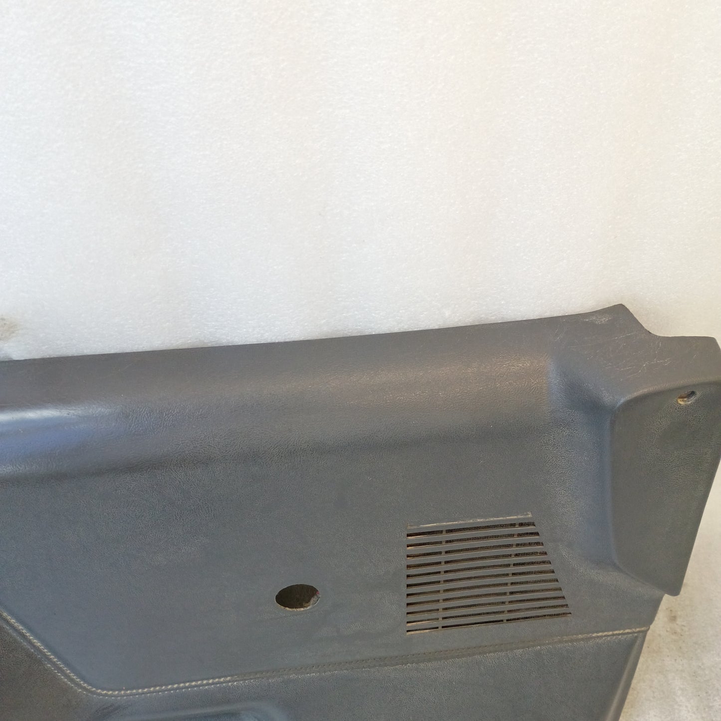 Dark gray door panel for 1987-1991 Ford Bronco, F-150, F-250, F-350 with manual windows, featuring a speaker grill.