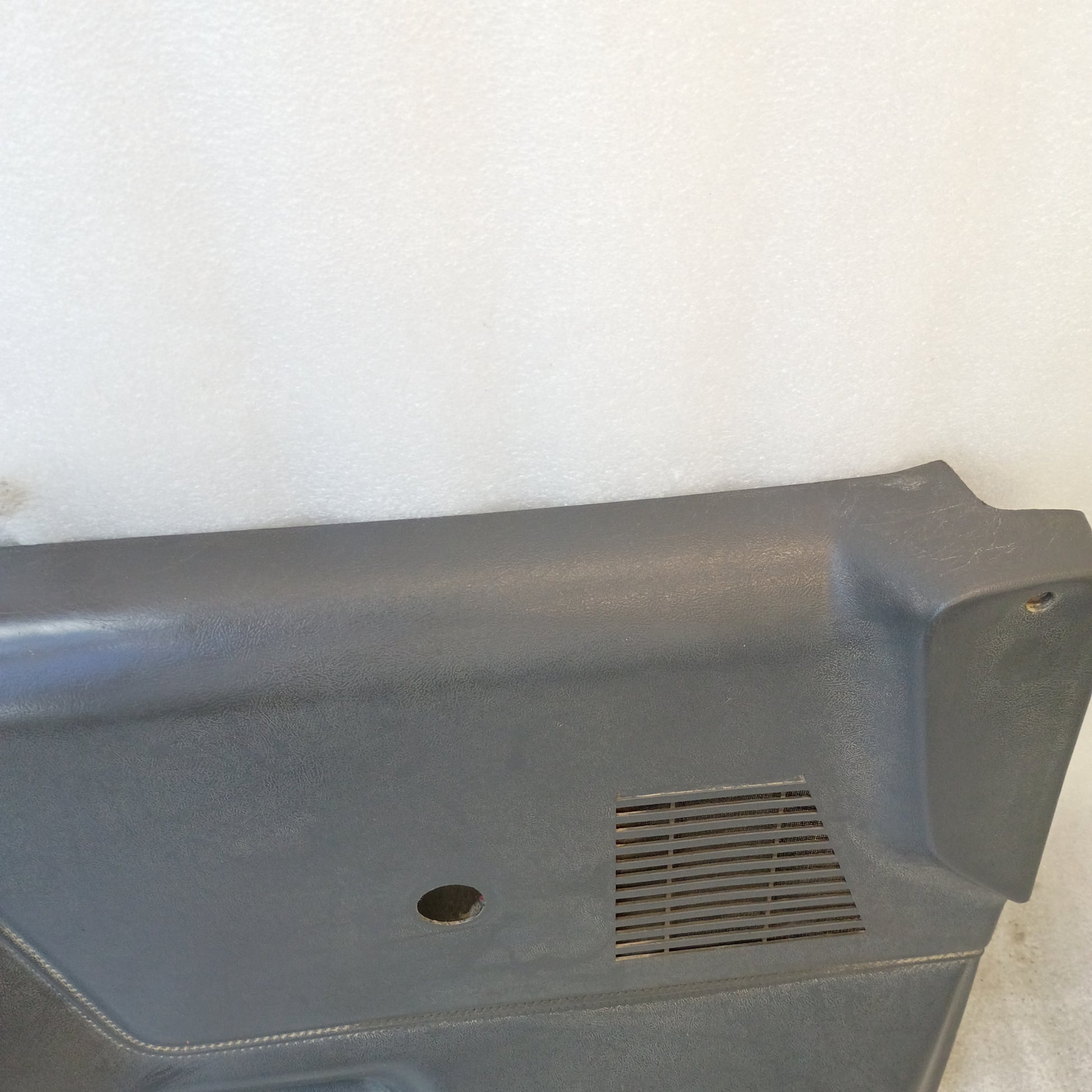 Dark gray door panel for 1987-1991 Ford Bronco, F-150, F-250, F-350 with manual windows, featuring a speaker grill.