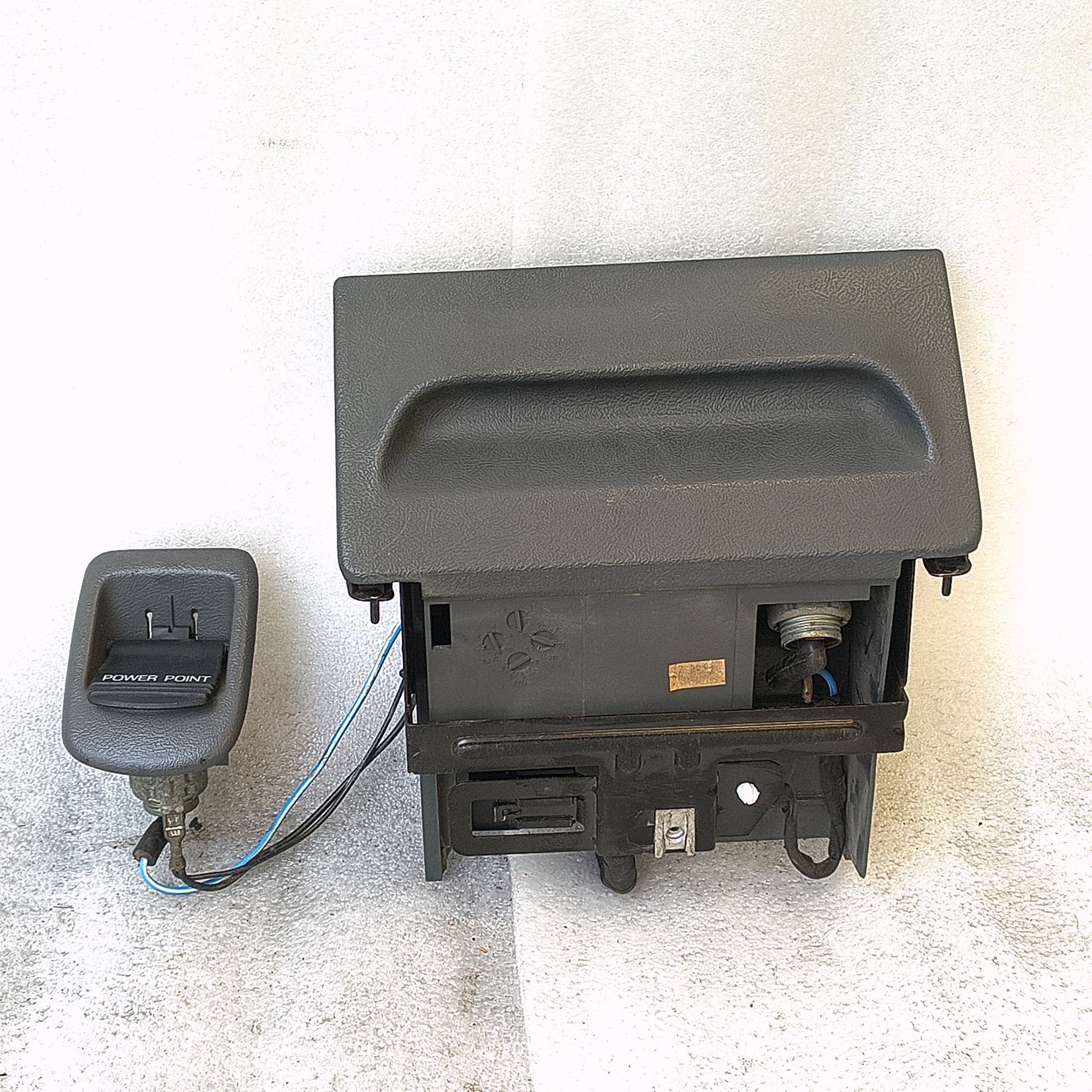 Granite Gray ashtray assembly with power port, mounting bracket, and refurbished wire harness for 1992-1996 Ford trucks.
