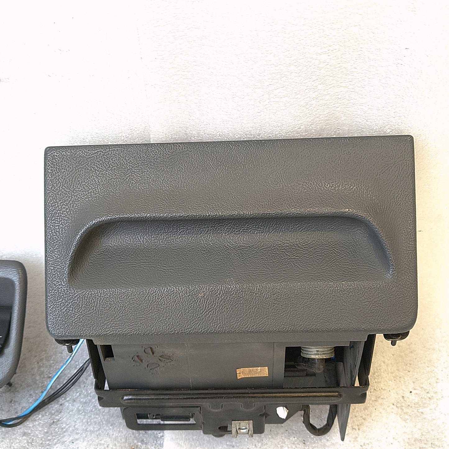 Granite gray ashtray assembly for 1992-1996 Ford F150, F250, F350, Bronco with mounting bracket, power port, and wire harness.