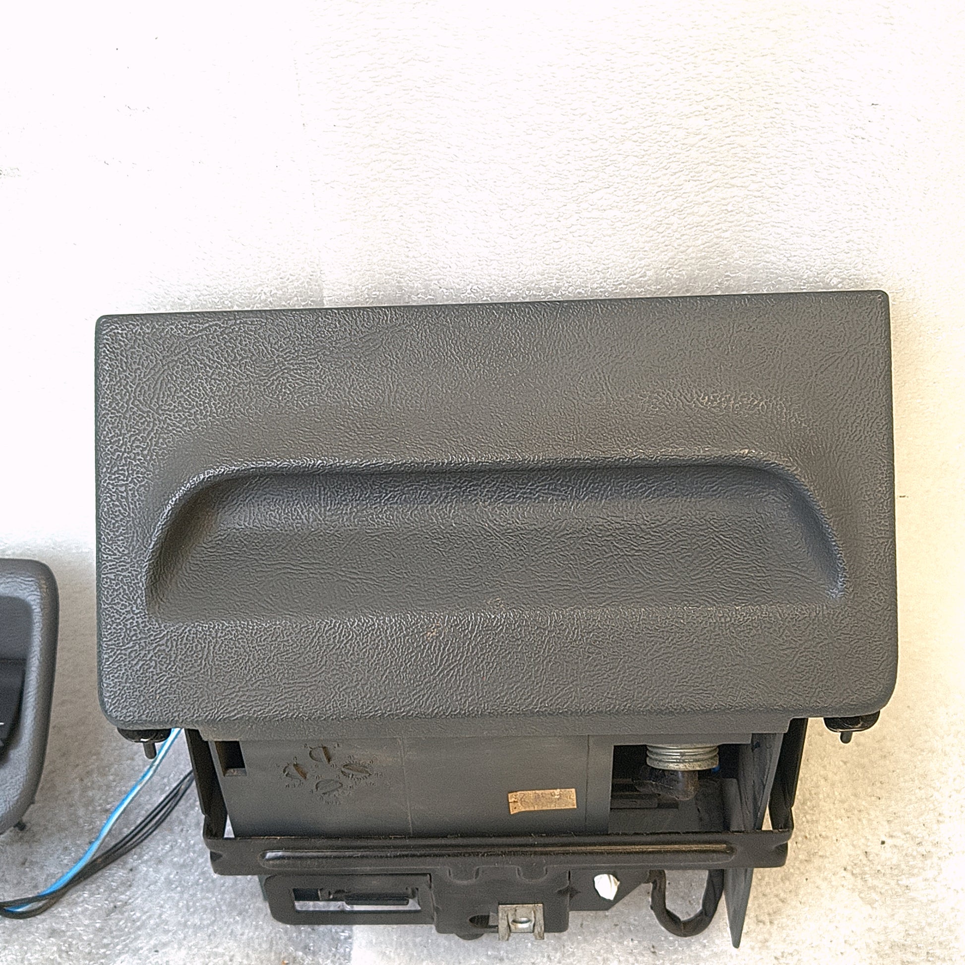 Granite gray ashtray assembly for 1992-1996 Ford F150, F250, F350, Bronco with mounting bracket, power port, and wire harness.