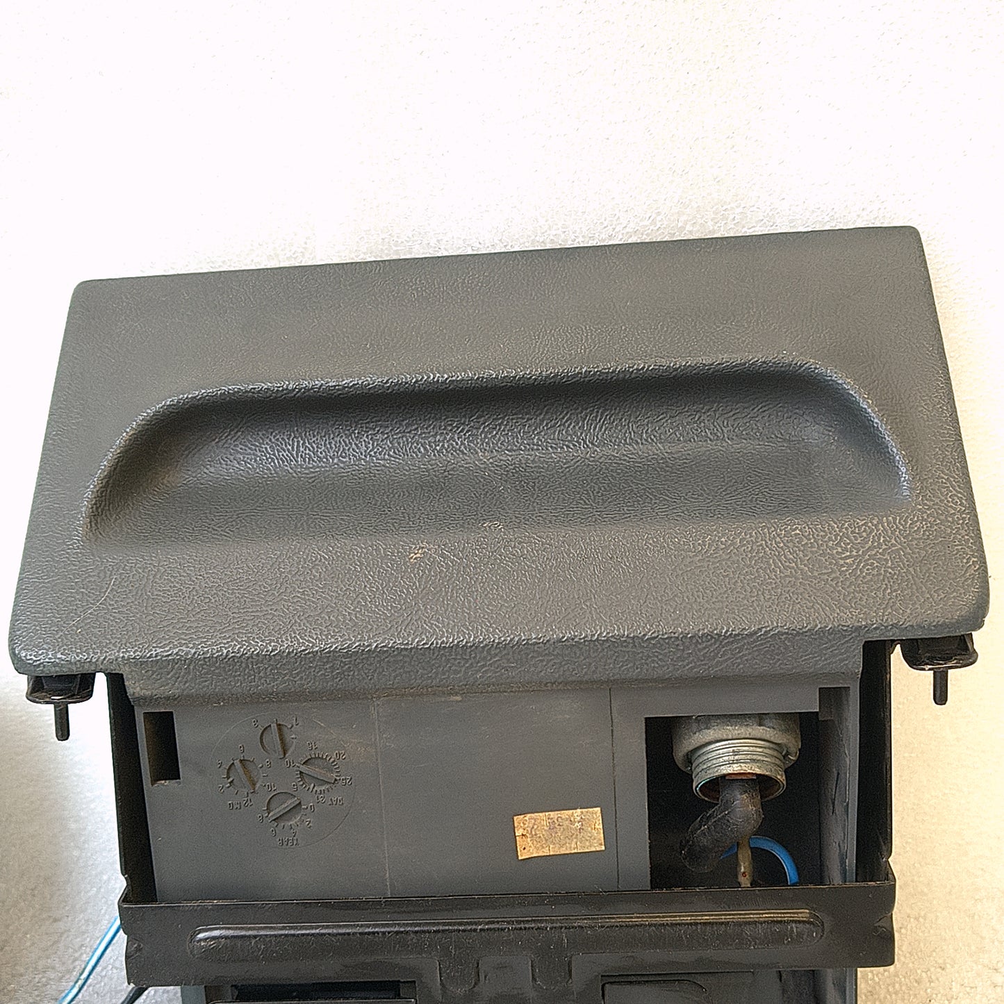 Dark gray ashtray assembly with power port and wire harness for 1992-1996 Ford F-series trucks and Bronco.