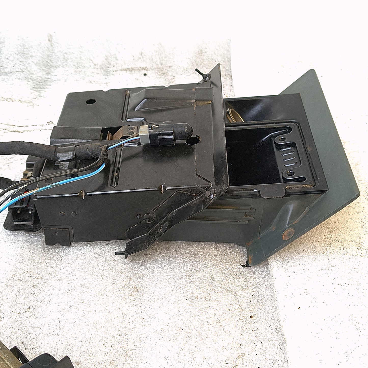 Granite gray ashtray assembly with wire harness for 1992-1996 Ford F-Series trucks and Bronco, shown with mounting bracket.