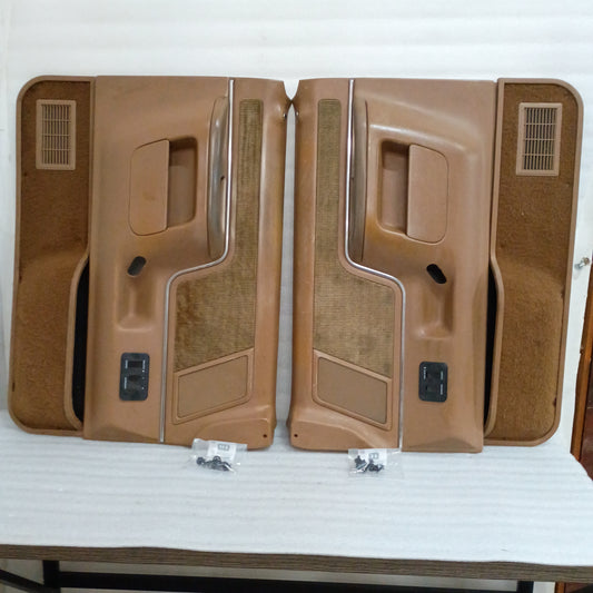 Pair of deluxe tan door panels for Ford F150, F250, F350, Bronco, with carpet inserts, power switch bezels, excellent condition.