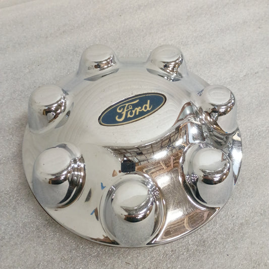 Chrome Ford 7-lug center cap with logo, compatible with 1999-2004 F-250/F-350, part number F75A-1A096-BD. Minor scuffs present.