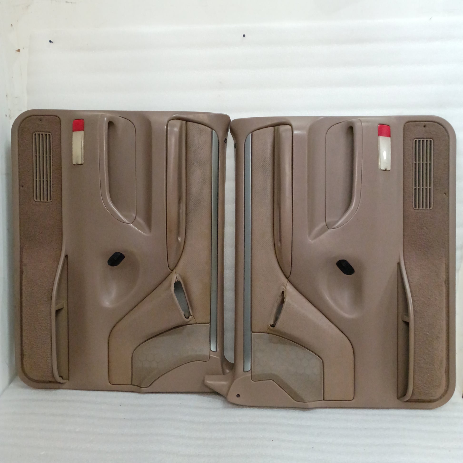 Tan Ford F150-F350 door panels with silver trim, red corner reflectors, and speaker grills, for models 1992-1997.