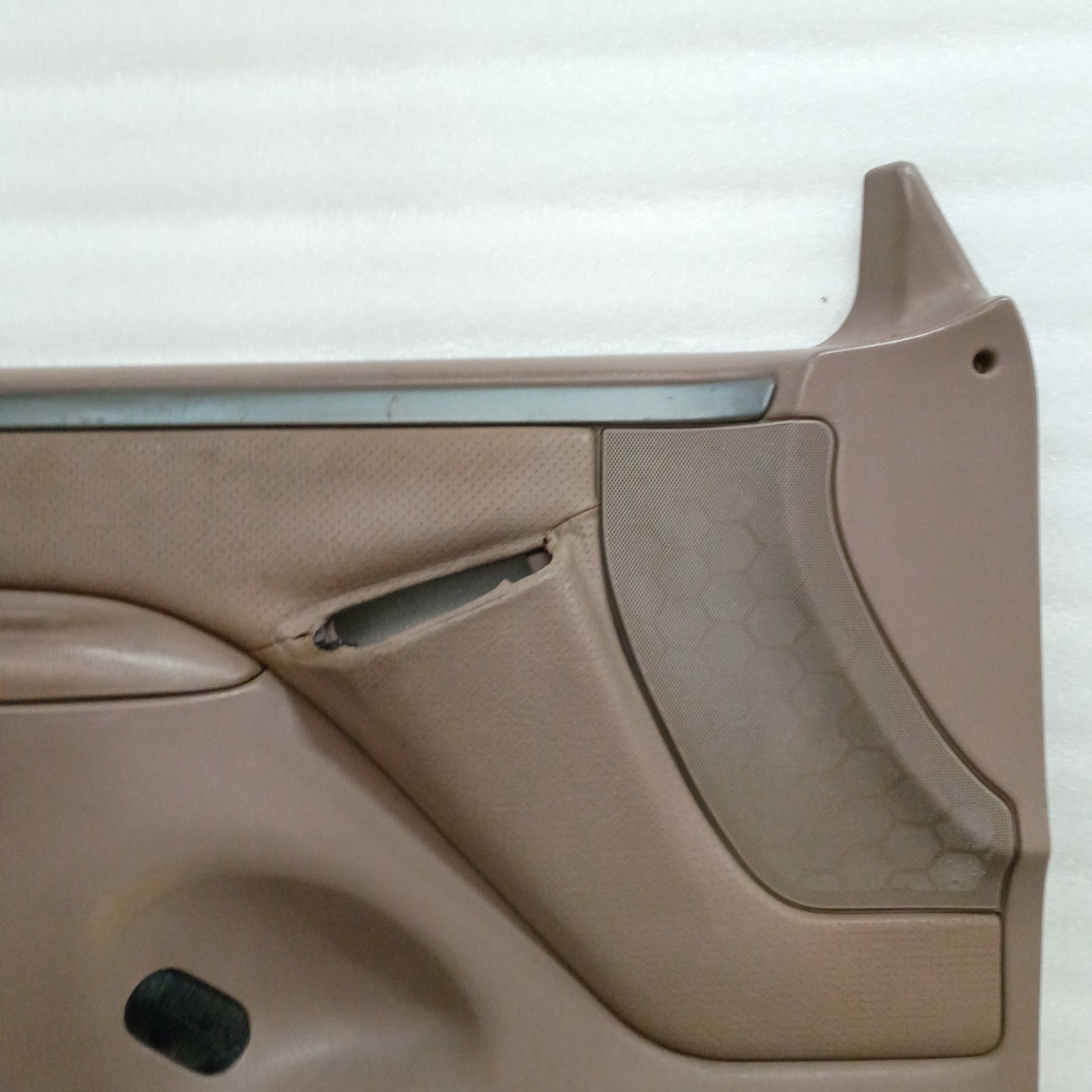 Tan Ford door panel with textured sections and trim for 1992-1997 F-Series/Bronco; minor wear and upgraded brackets.