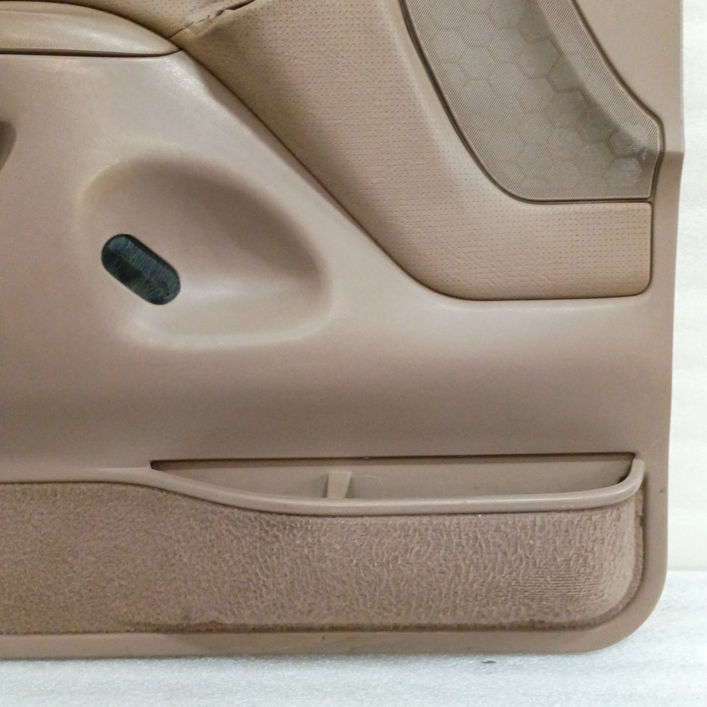 Tan door panel for 1992-1997 Ford F-Series and Bronco, featuring black trim, vinyl armrest, and carpeted map pocket.