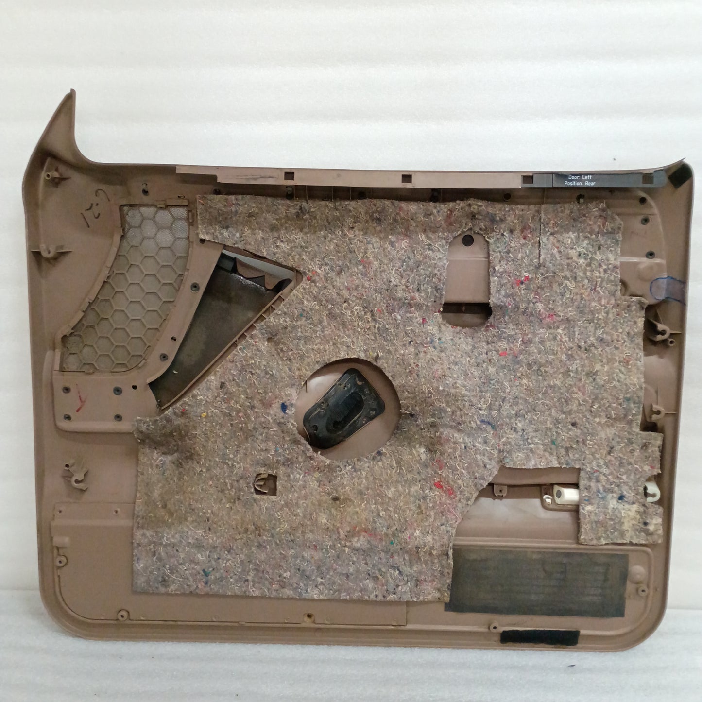Tan door panel for Ford F150-F350 and Bronco, featuring trim strips, speaker grills, and power switch mounting connectors.