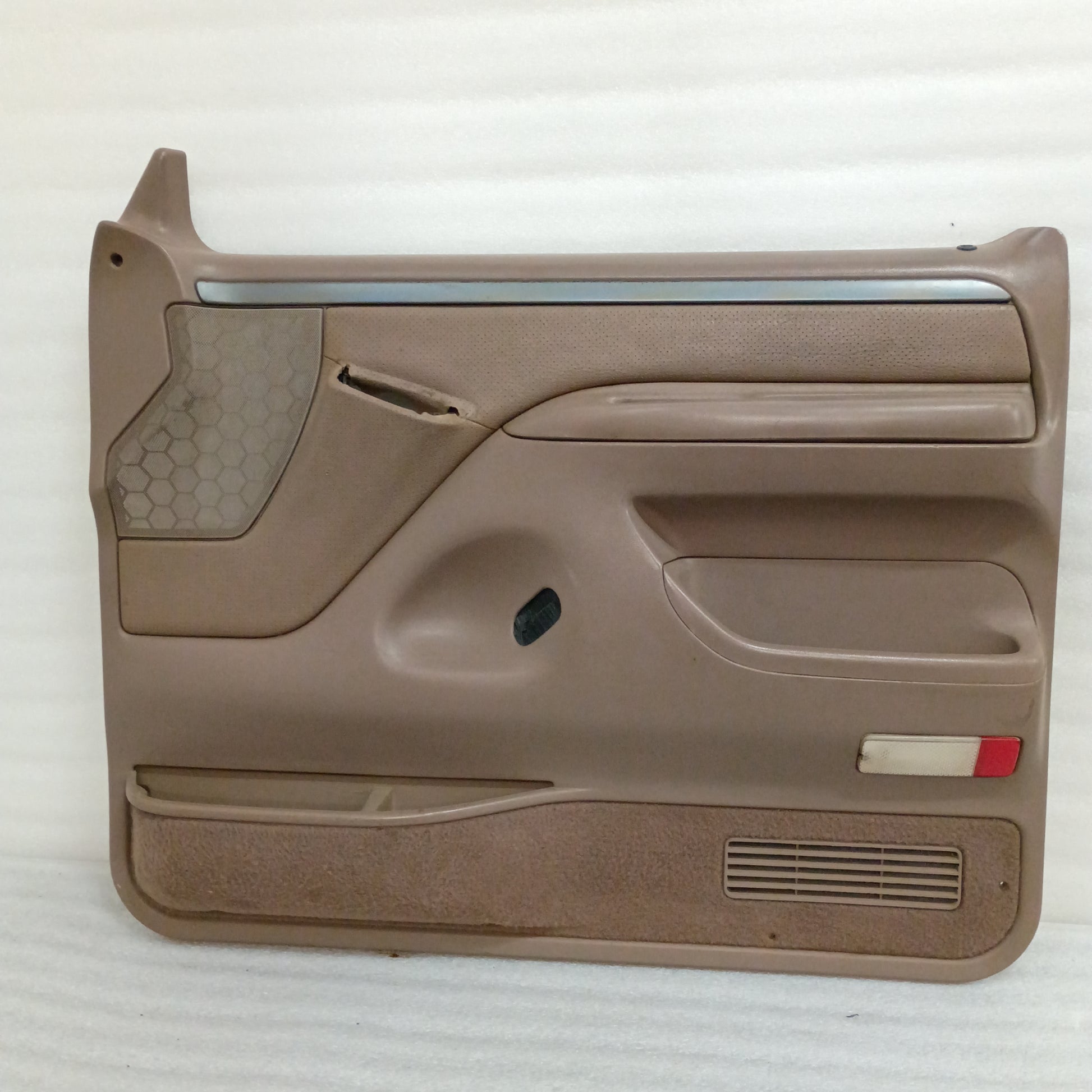 Tan door panel for Ford F150, F250, F350, and Bronco, 1992-1997, with power windows/locks, silver and black trim.