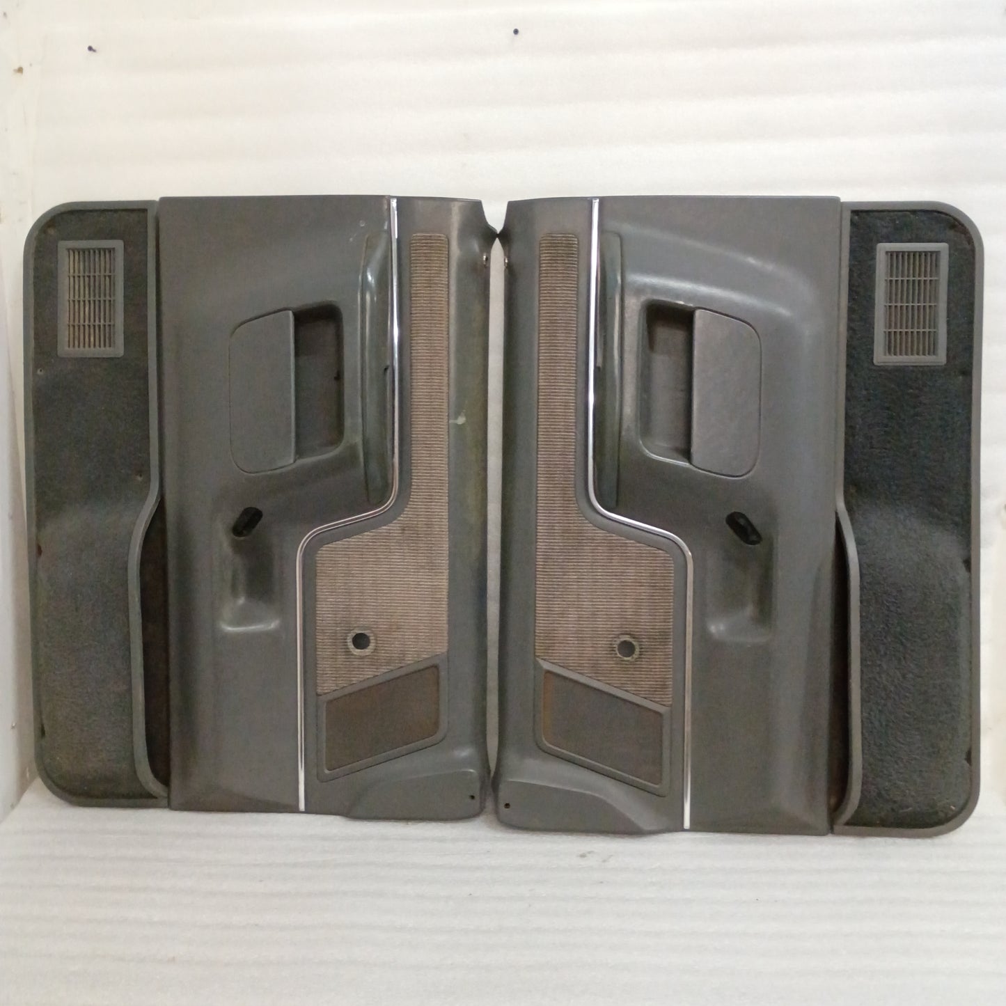 Dark gray door panels set for 1987-1991 Ford F-Series/Bronco, featuring manual windows, carpeted map pockets, and speaker grilles.