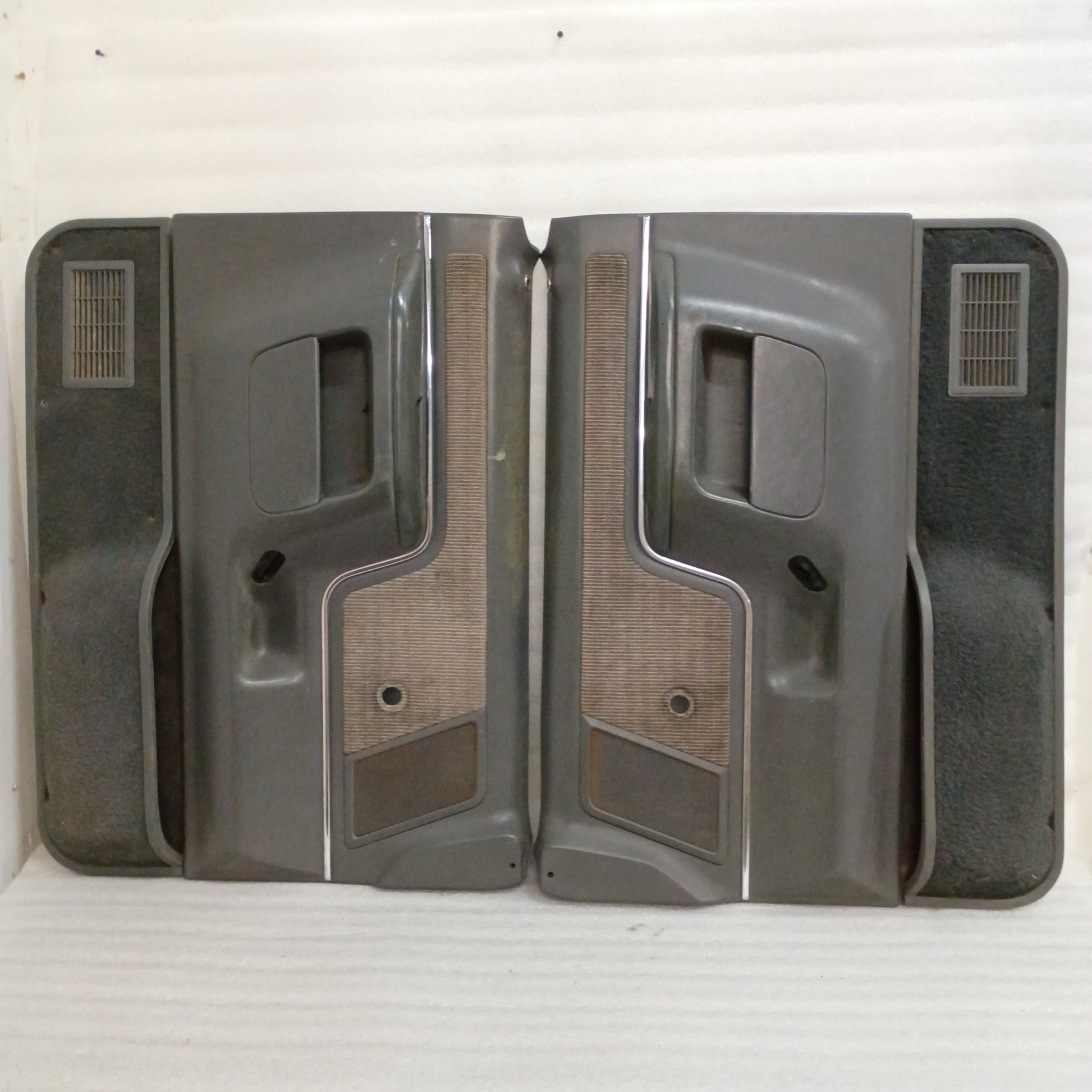 Dark gray door panels set for 1987-1991 Ford F-Series/Bronco, featuring manual windows, carpeted map pockets, and speaker grilles.
