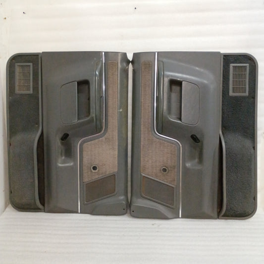 Dark gray door panels set for 1987-1991 Ford F-Series/Bronco, featuring manual windows, carpeted map pockets, and speaker grilles.