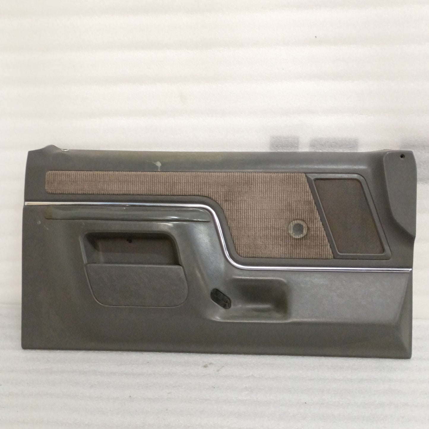 Deluxe dark gray door panel for 87-91 Ford F150/F250/F350/Bronco with carpeted map pocket insert and manual window cutout.