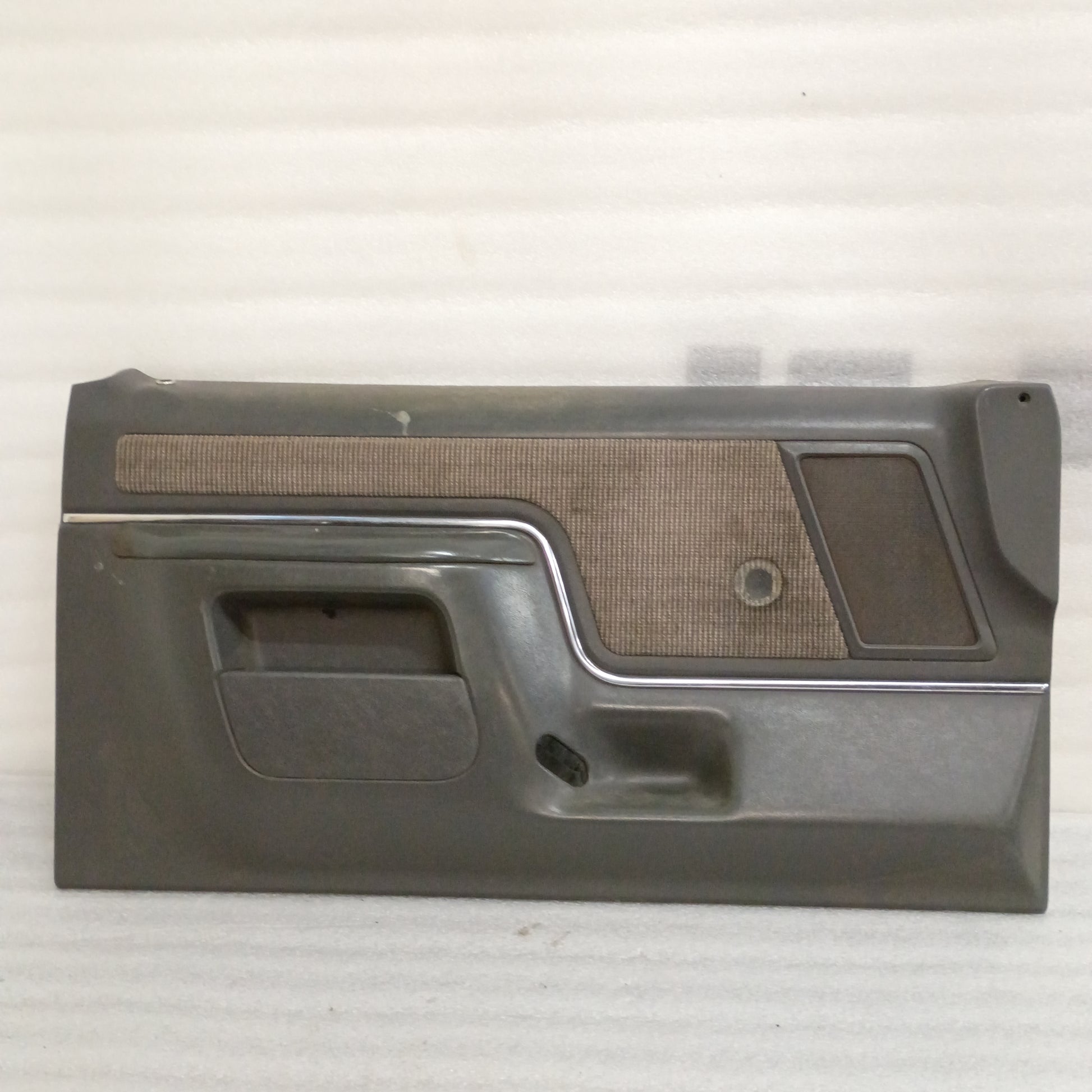 Deluxe dark gray door panel for 87-91 Ford F150/F250/F350/Bronco with carpeted map pocket insert and manual window cutout.