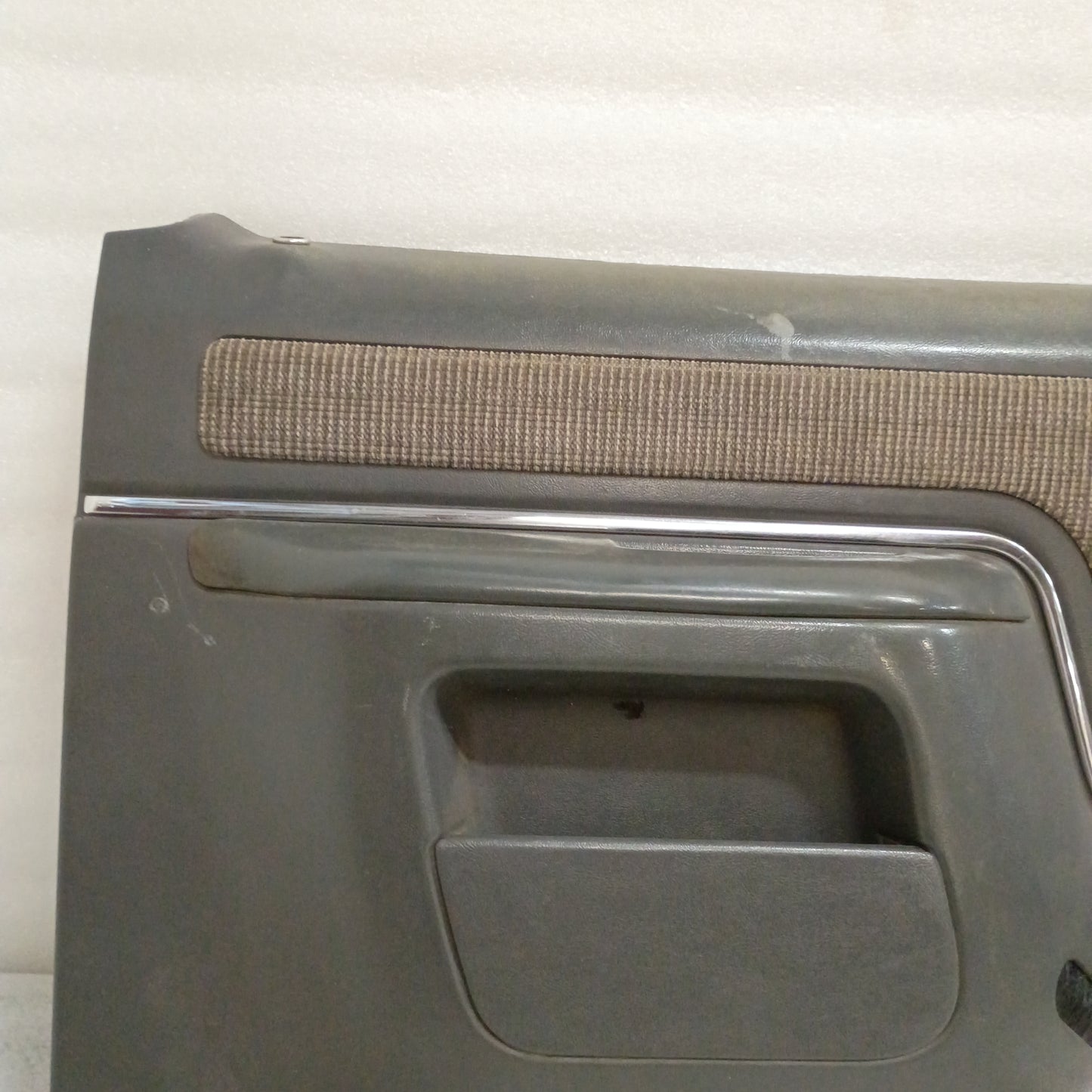 Dark gray Ford door panel with chrome trim and carpeted map pocket, suitable for 1987-1991 F150, F250, F350, and Bronco.