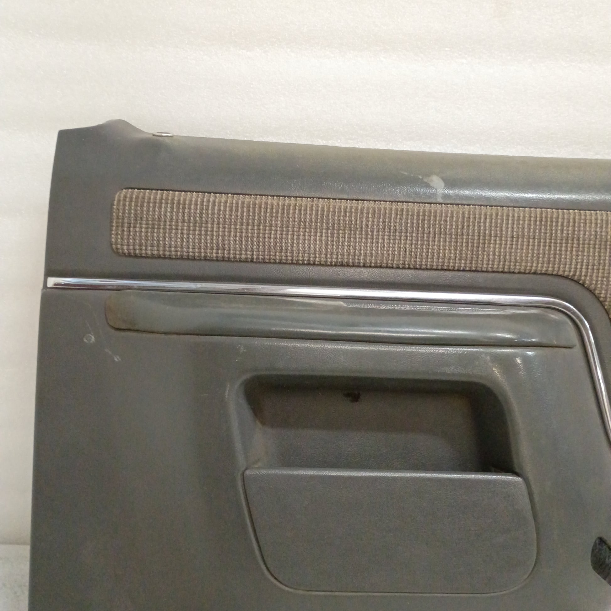 Dark gray Ford door panel with chrome trim and carpeted map pocket, suitable for 1987-1991 F150, F250, F350, and Bronco.