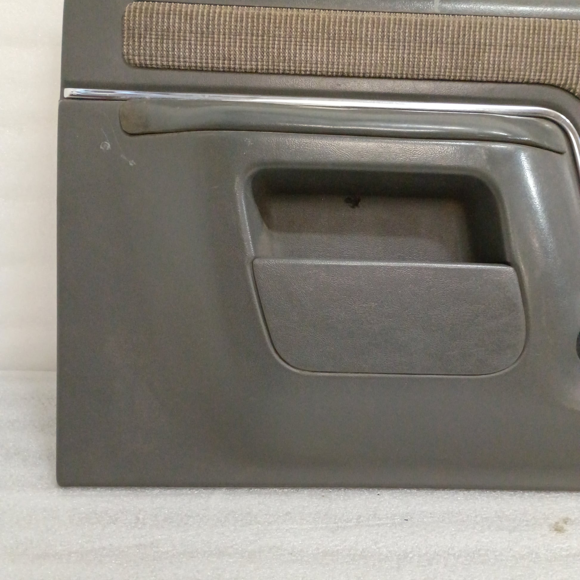 Dark gray deluxe door panel with manual window crank area for Ford F150, F250, F350, Bronco, 1987-1991 models.