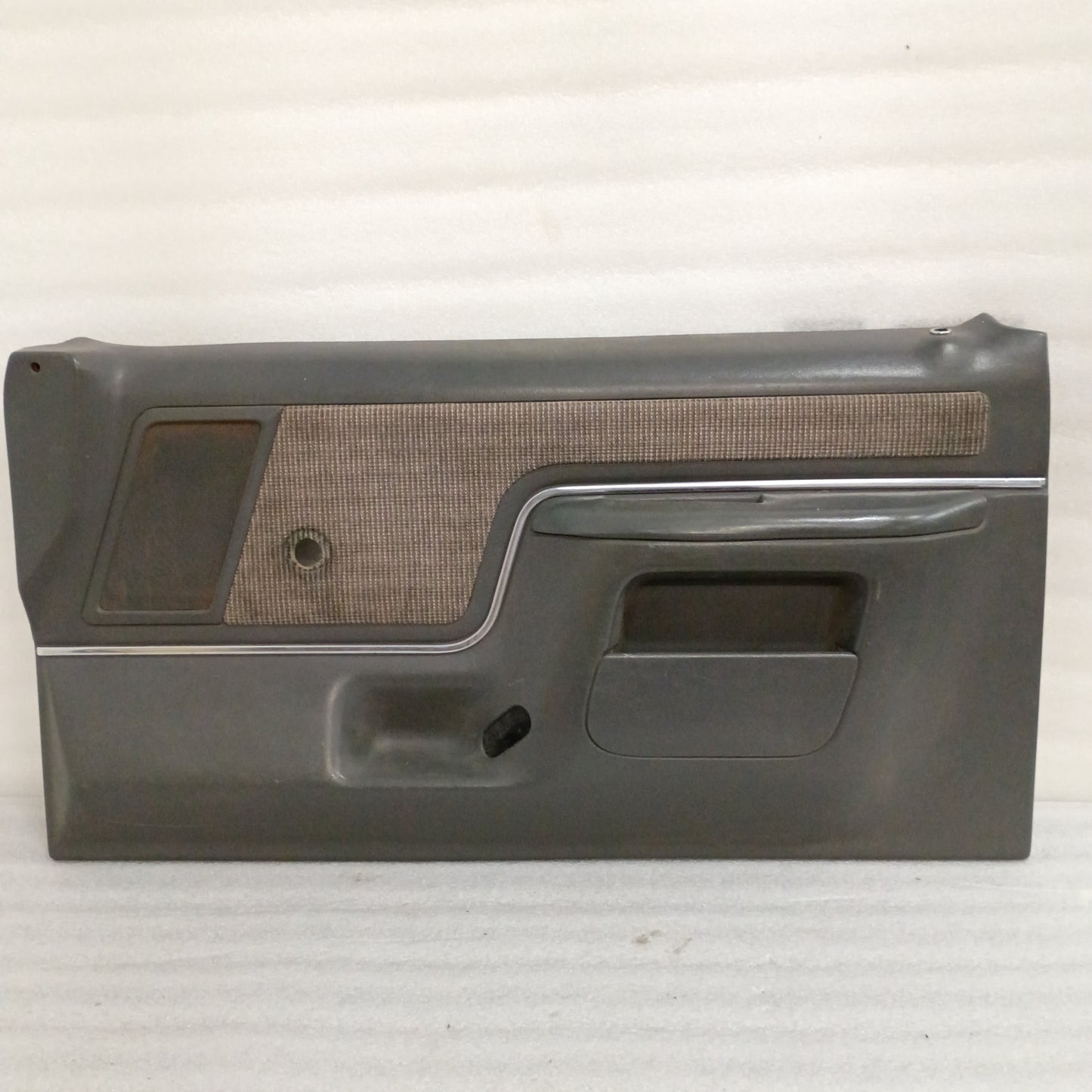 Deluxe dark gray door panel for 1987-1991 Ford F150-F350, Bronco; manual window, carpeted map pocket, excellent condition.
