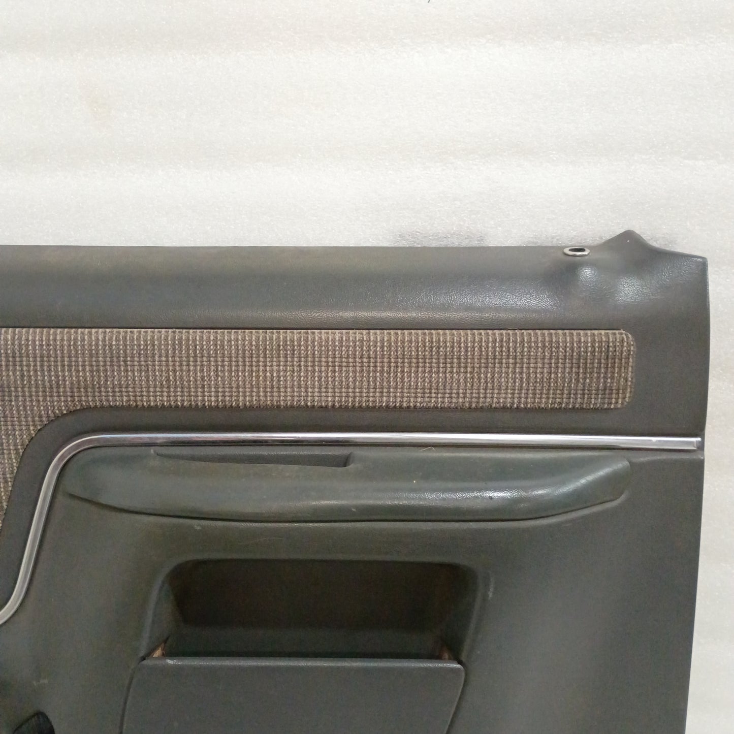 Dark gray Ford door panel with manual window crank opening, carpeted map pocket, and chrome trim. Suitable for 1987-1991 F150, F250, F350, Bronco.
