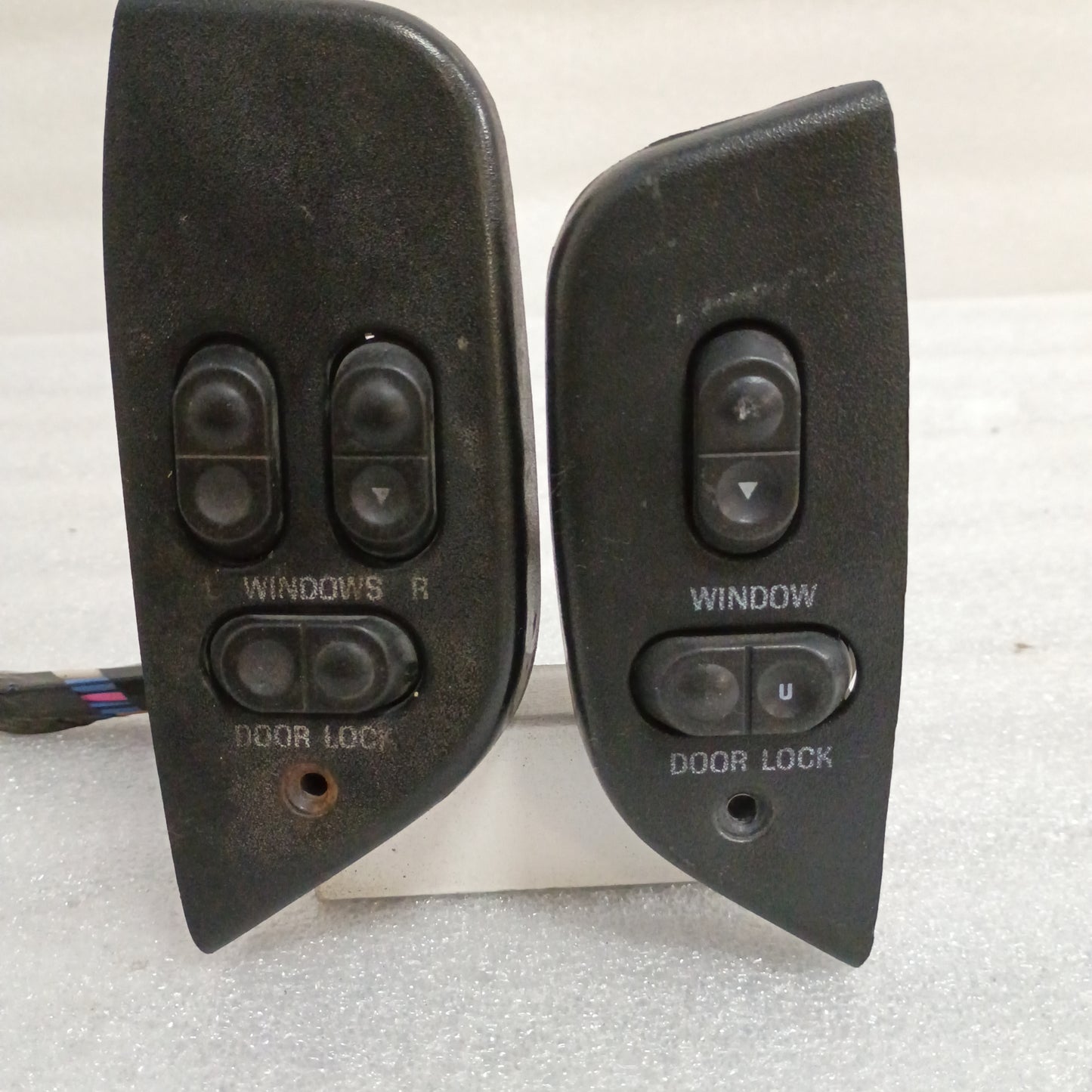 Black power window and door lock switch set for 92-96 Ford trucks, includes bezels and wire pigtail.