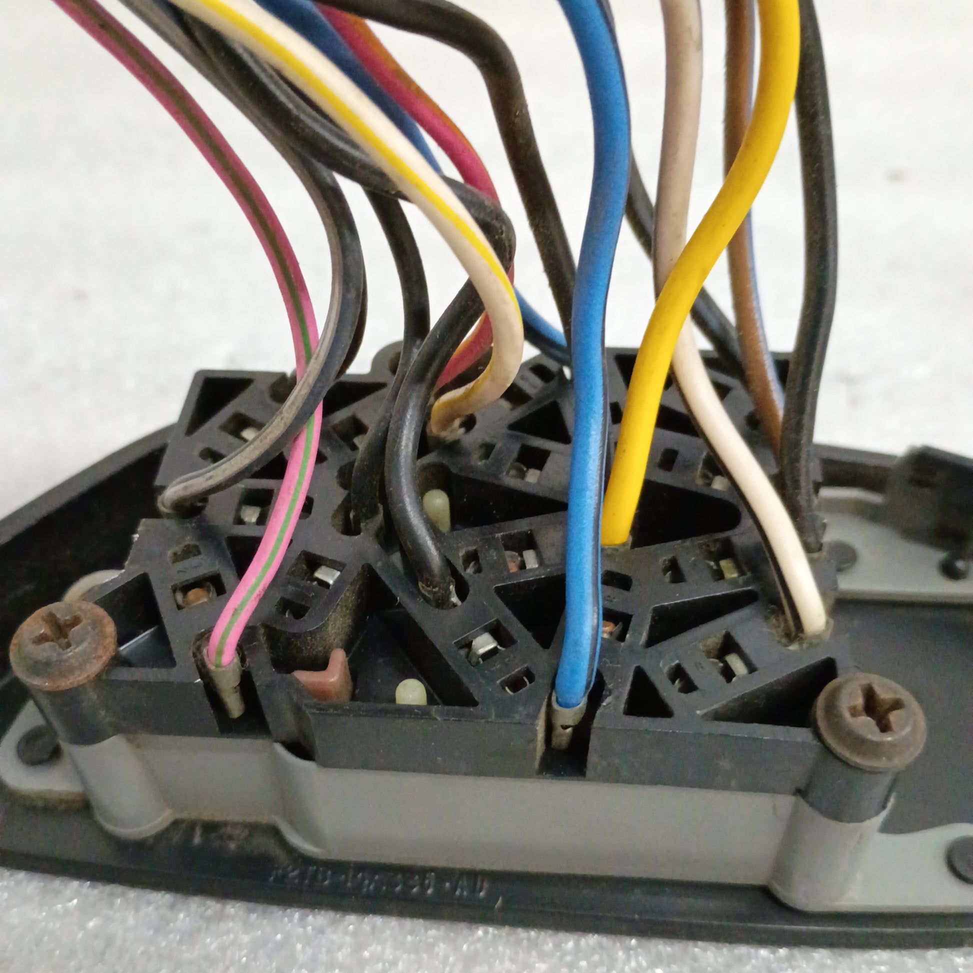 Black power window and lock switch with exposed wiring for 1992-1996 Ford Bronco, F-150, F-250, F-350 models.