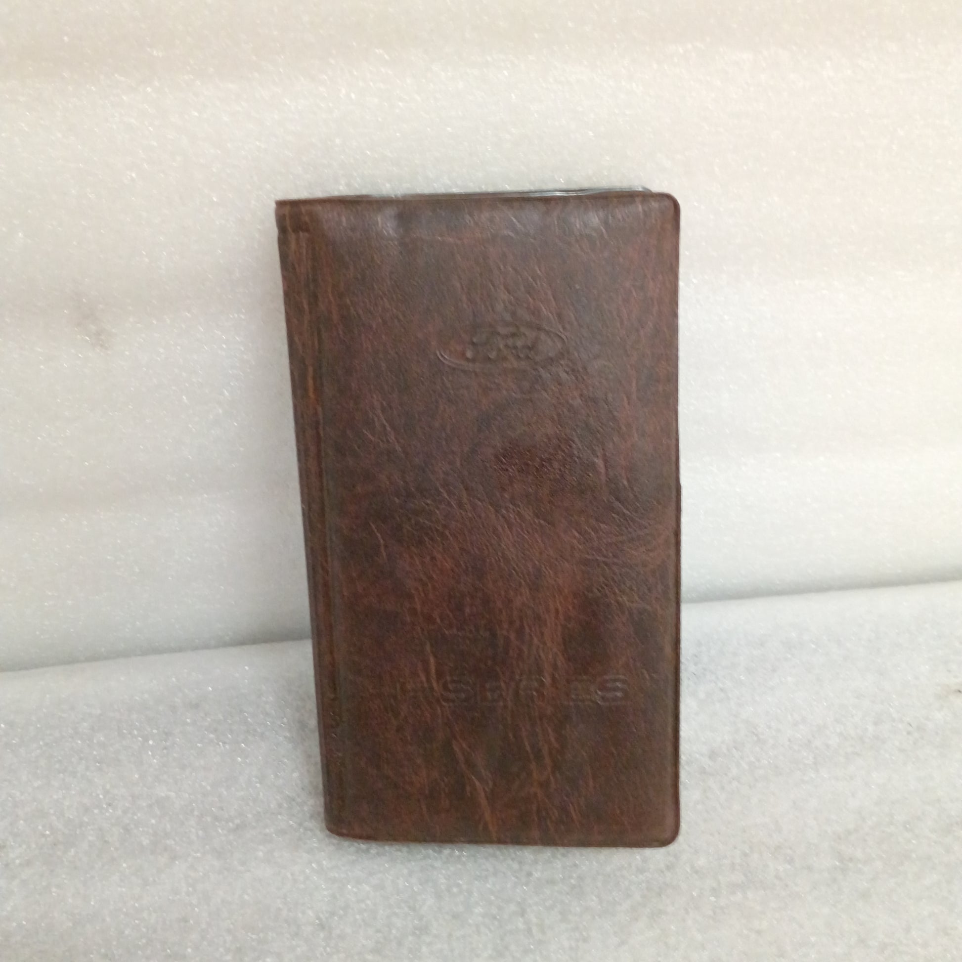 OEM 1996 Ford F-Series owner's manual case, brown leather, shows wear, compatible with F-150, F-250, F-350.