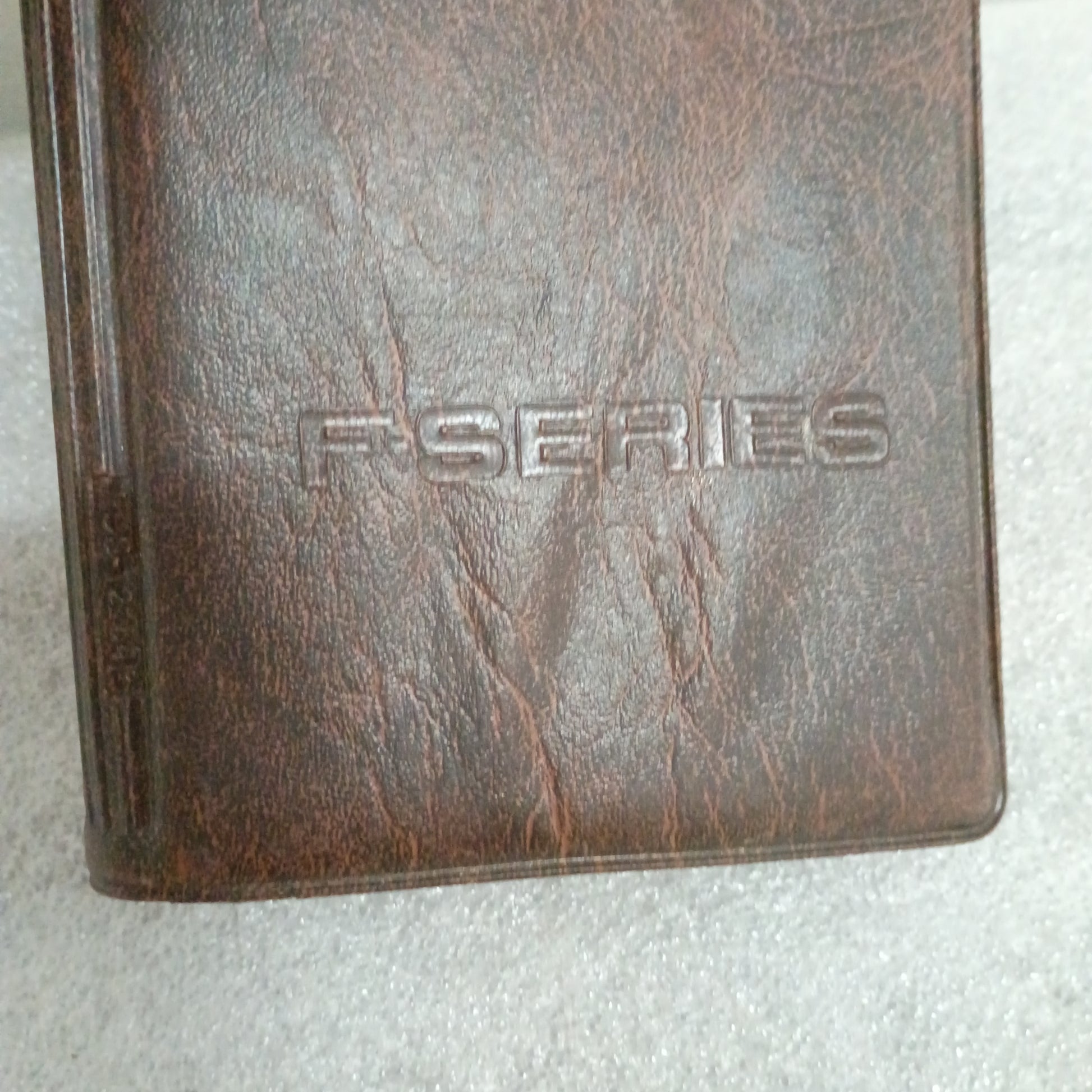 Brown leather cover of a 1996 F-Series Owner Guide showing embossed "F-SERIES" text, compatible with Ford F-150, F-250, F-350.