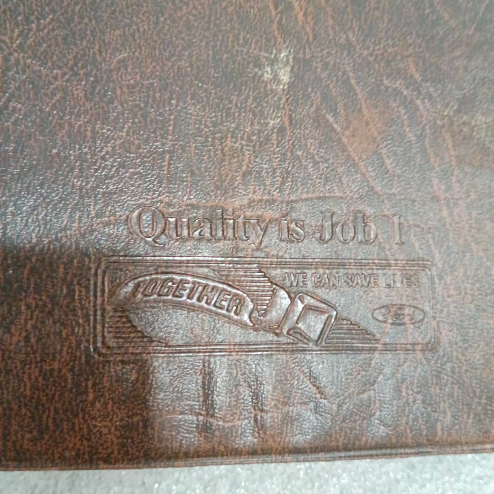 Brown embossed Ford manual cover with "Quality is Job 1" text, showing moderate wear. Suitable for 1996 F-Series trucks.
